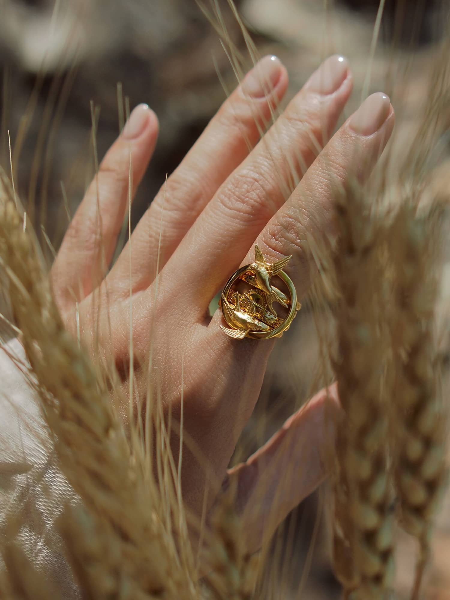 Beautifully designed stacking rings on a hand with a background of natural elements.