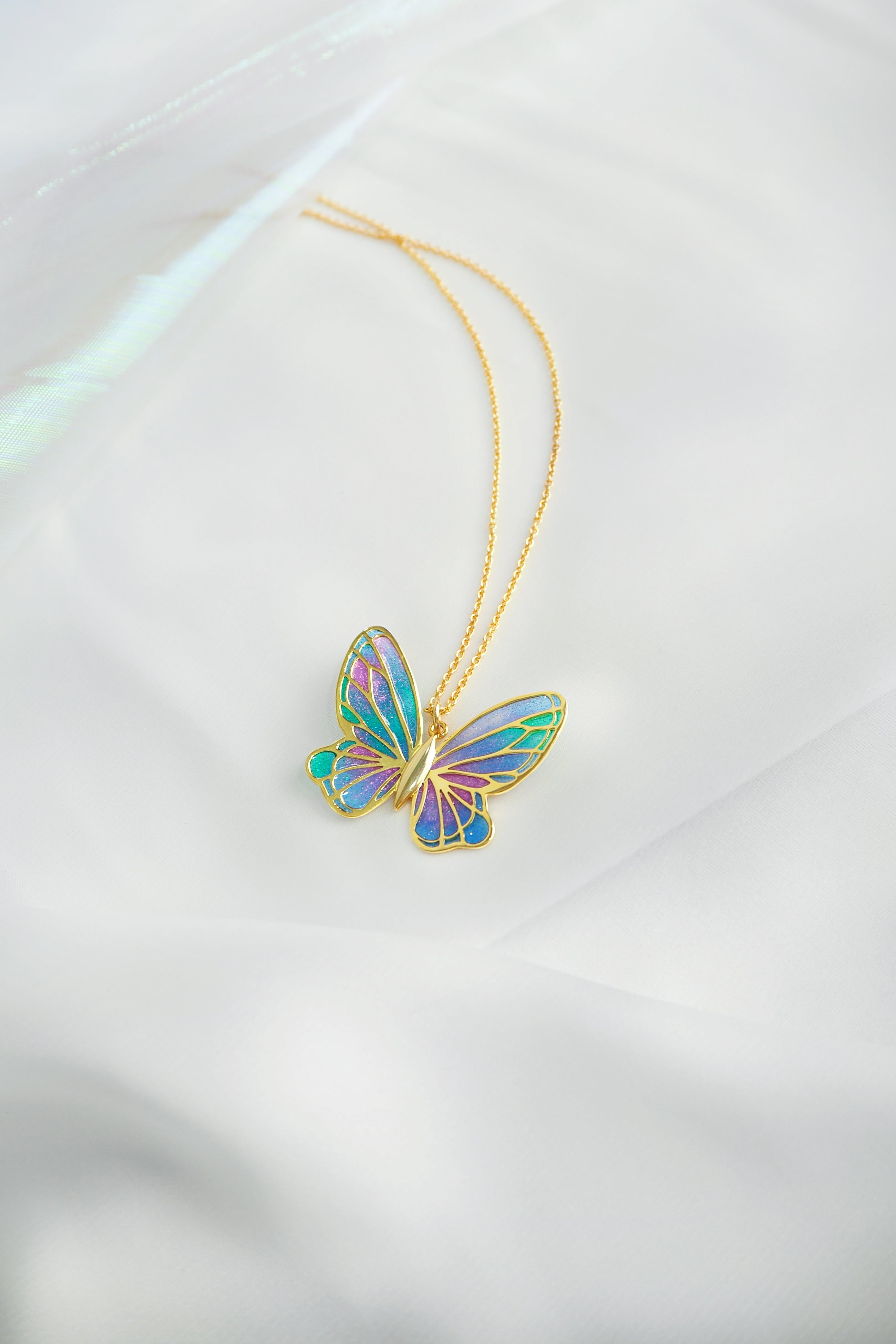 Stunning enamel butterfly necklace featuring vibrant hues and intricate design