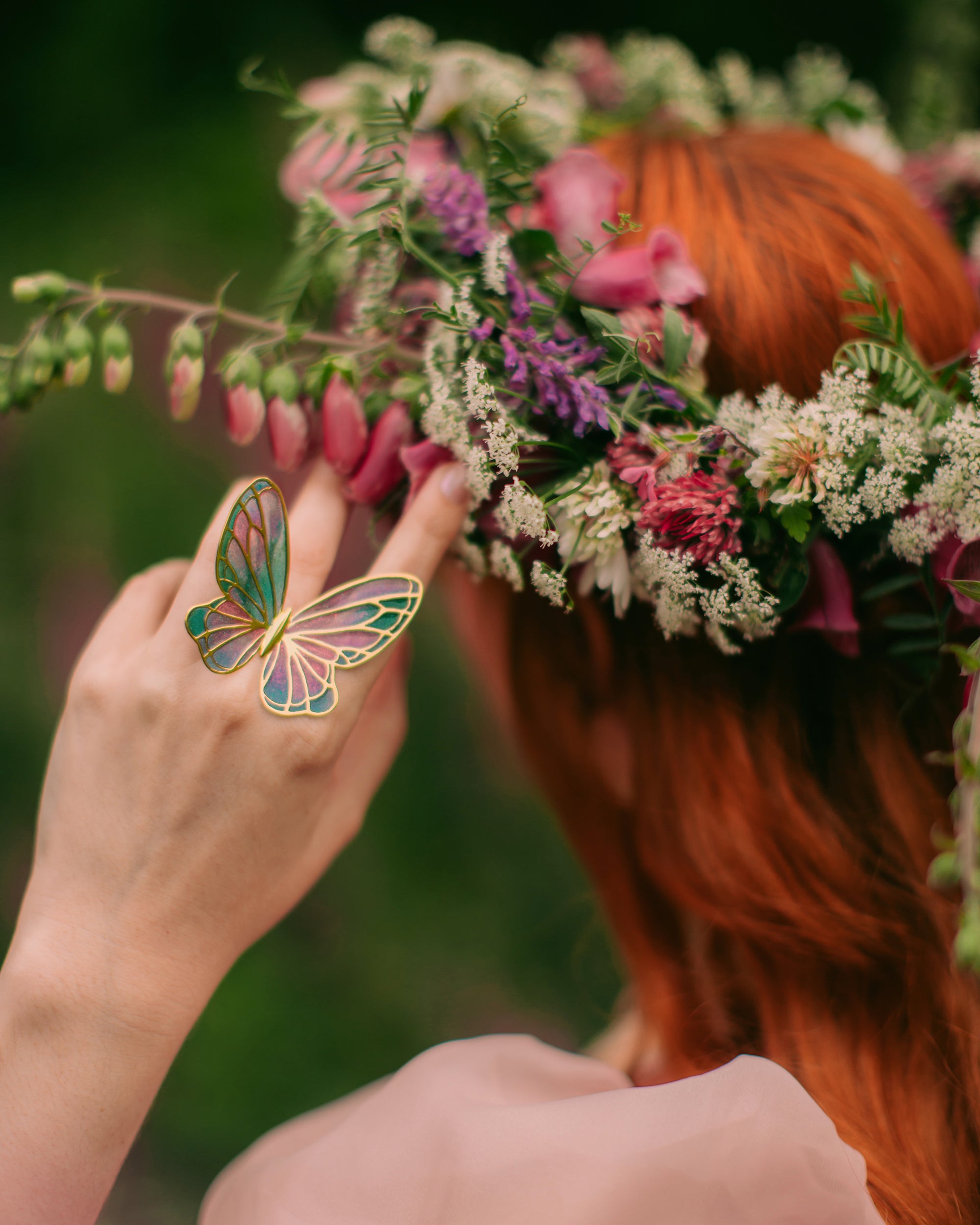 A Girl wear fairy butterfly ring with froal tiara on her head