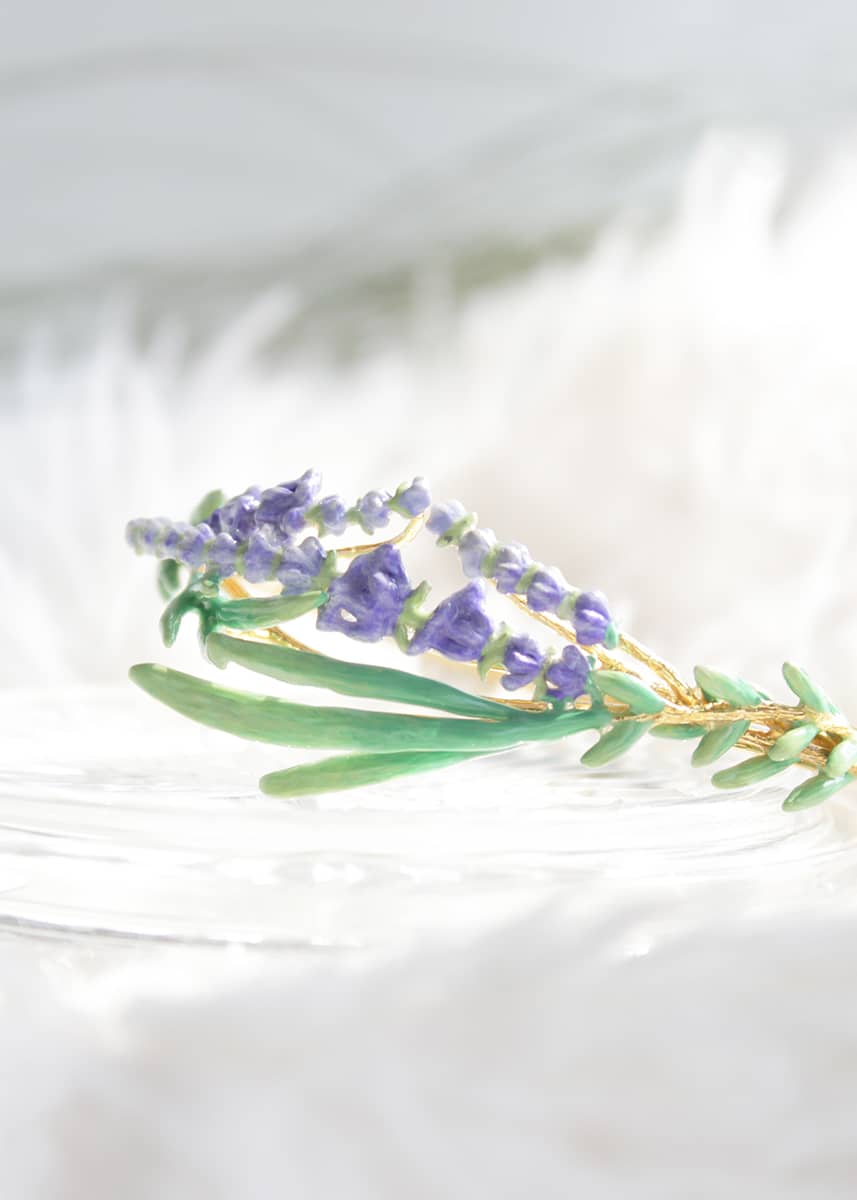 Charming lavender  bracelet featuring with green leaves and delicate purple flowers placed on  a white background.