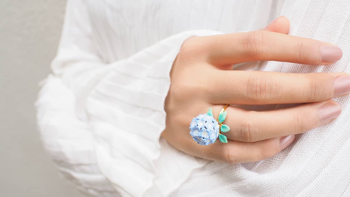 Blue hydrangea flower ring on a hand