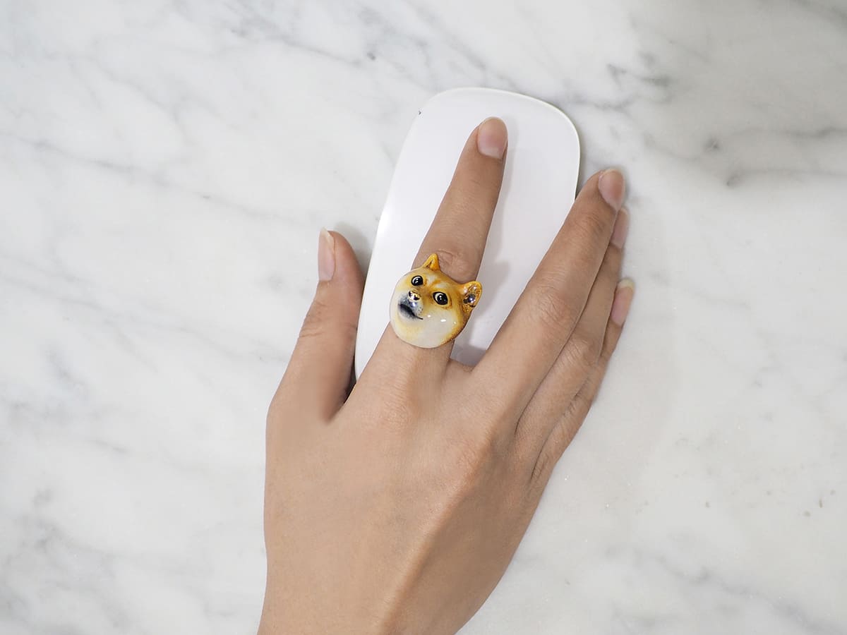 A fun ring featuring a dodge design on a hand holding a computer mouse.