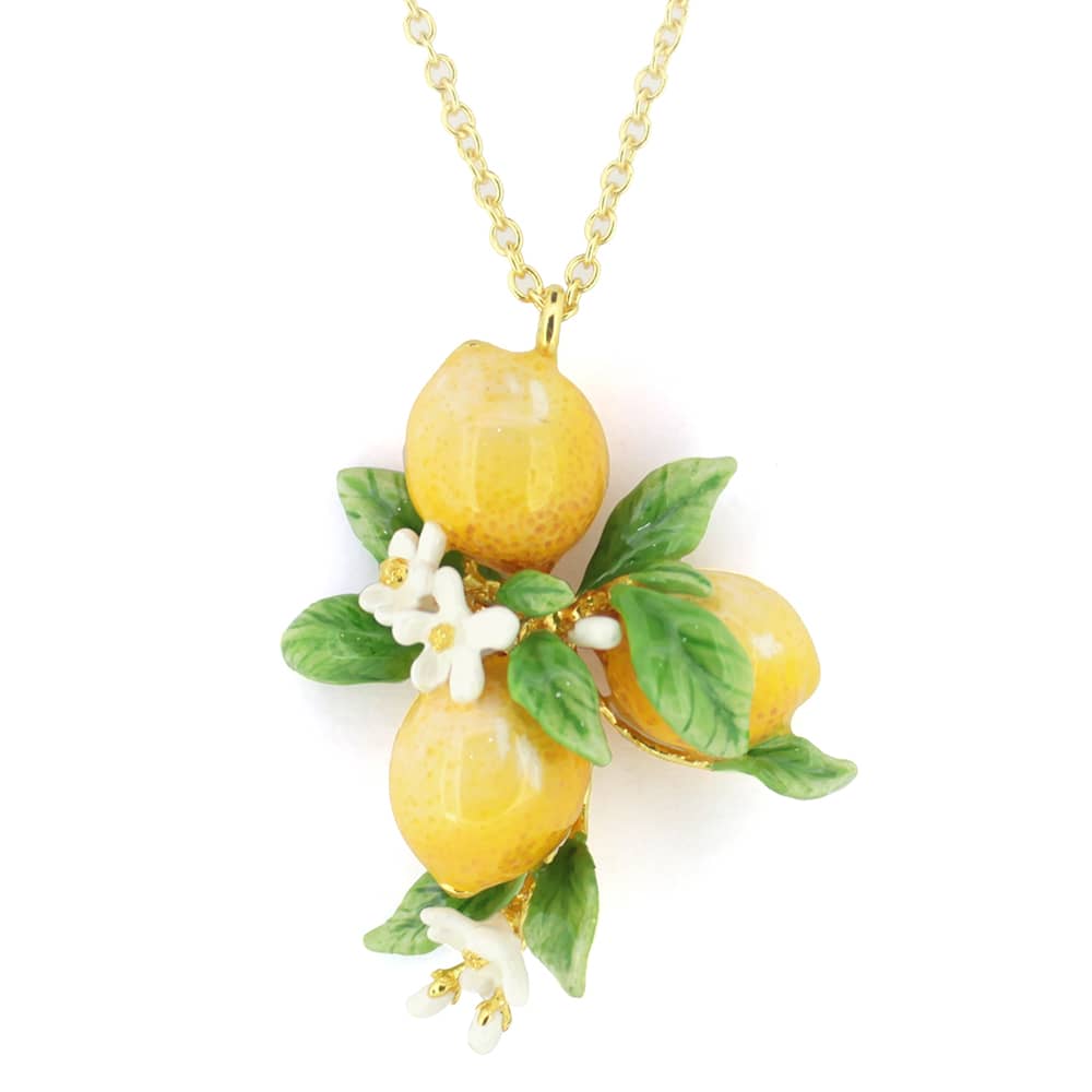 A golden chain necklace featuring three intricately crafted yellow lemons surrounded by green leaves and tiny white flowers.