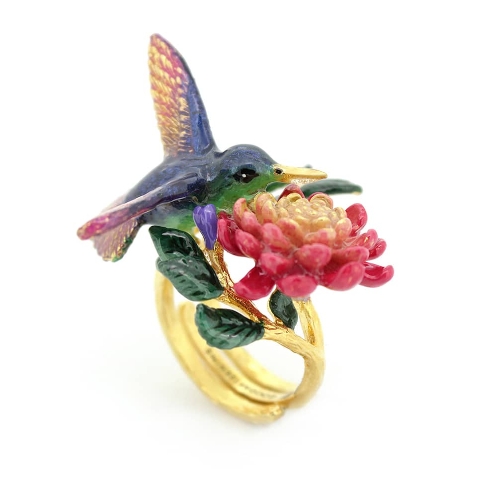 Nature-inspired ring showcasing a hummingbird and blooming flowers