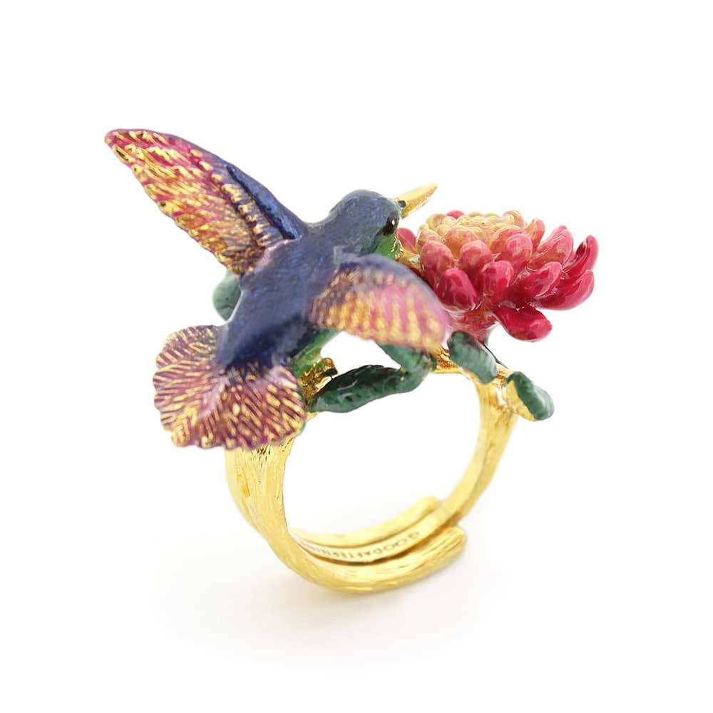 Nature-inspired ring showcasing a hummingbird and blooming flowers