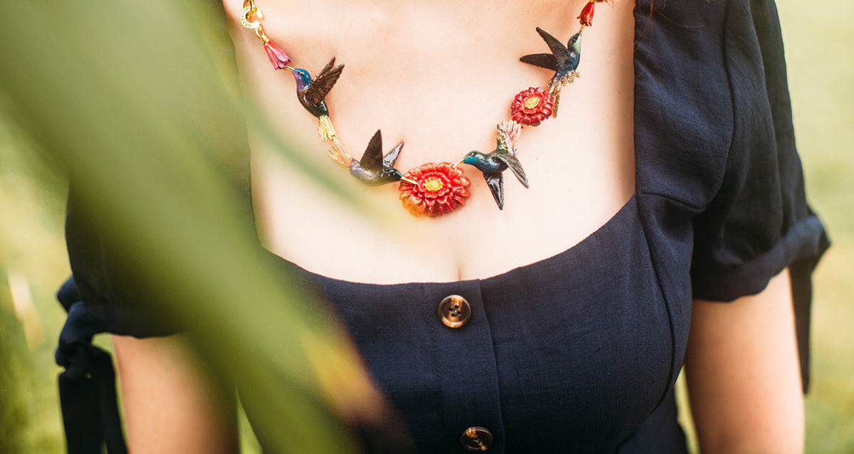 Stylish summer accessories showcasing a unique hummingbird necklace.