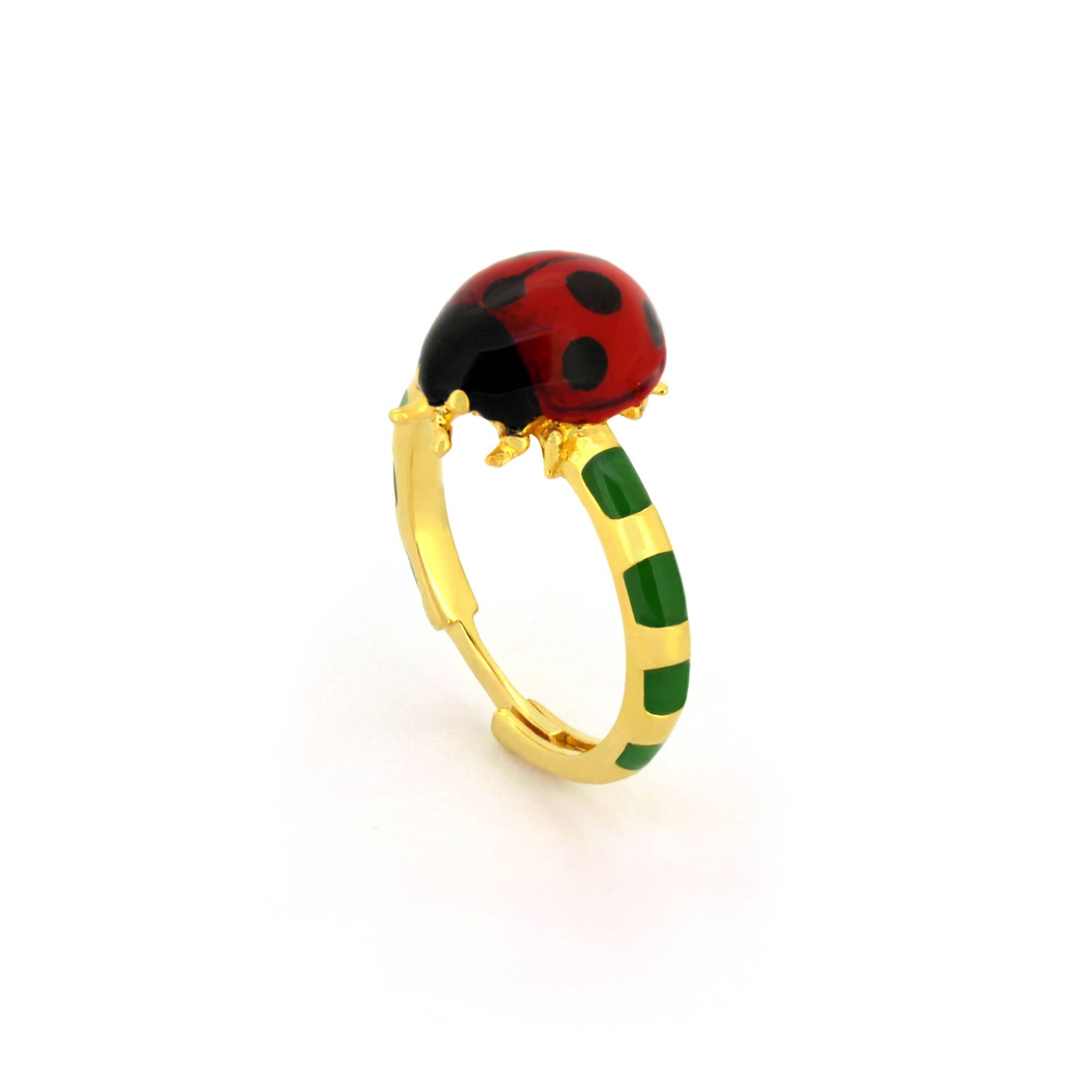 Gold ring featuring a vibrant ladybug design with red and black enamel detailing, set on a green and gold band.