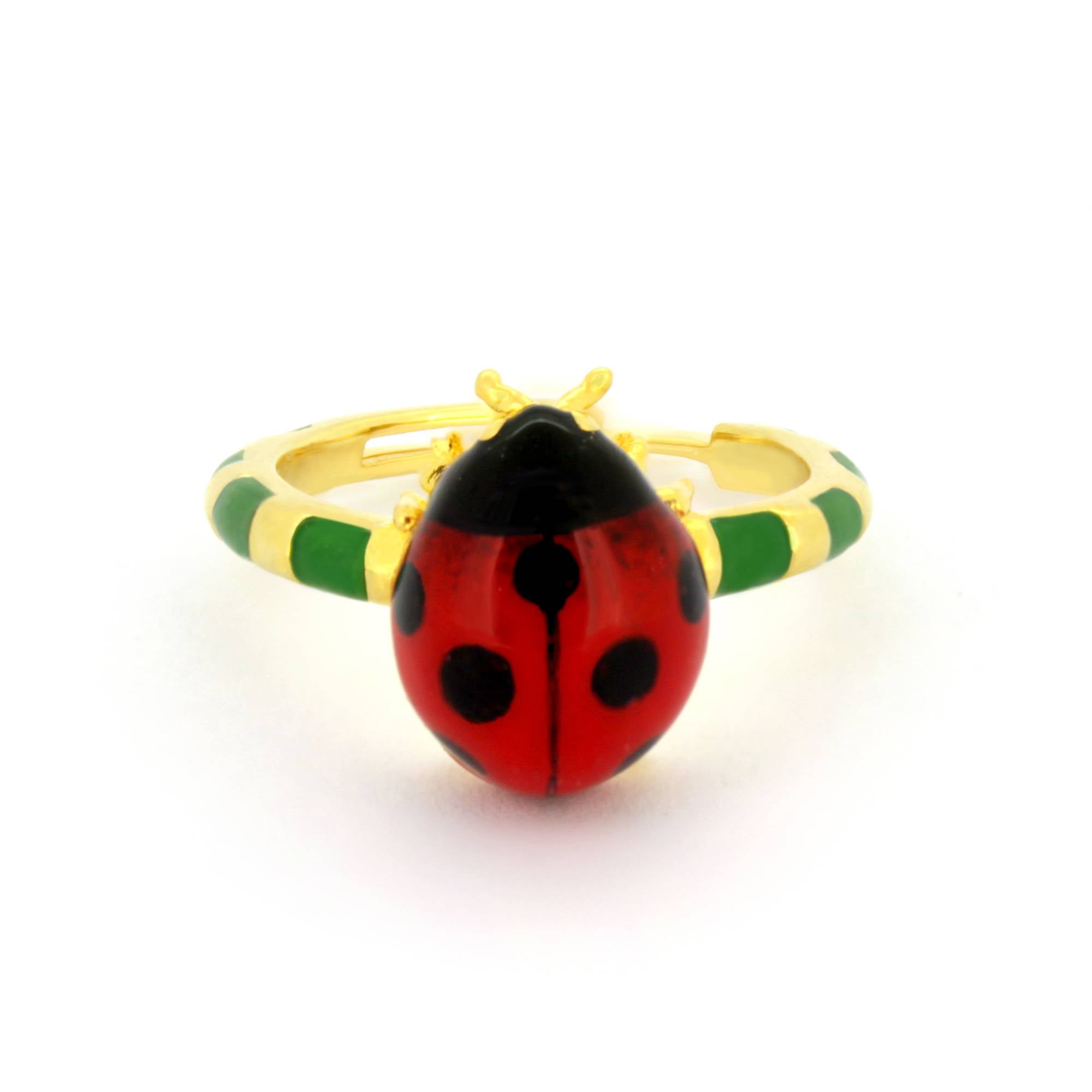 Gold ring featuring a vibrant ladybug design with red and black enamel detailing, set on a green and gold band.