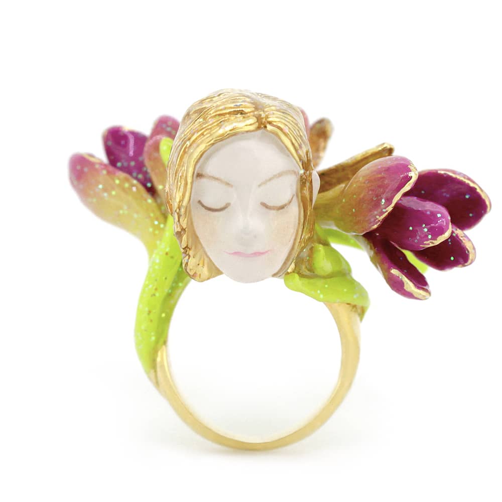 Colorful ring featuring a nymph's face surrounded by pink and green flowers, perfect for fantasy jewelry lovers.