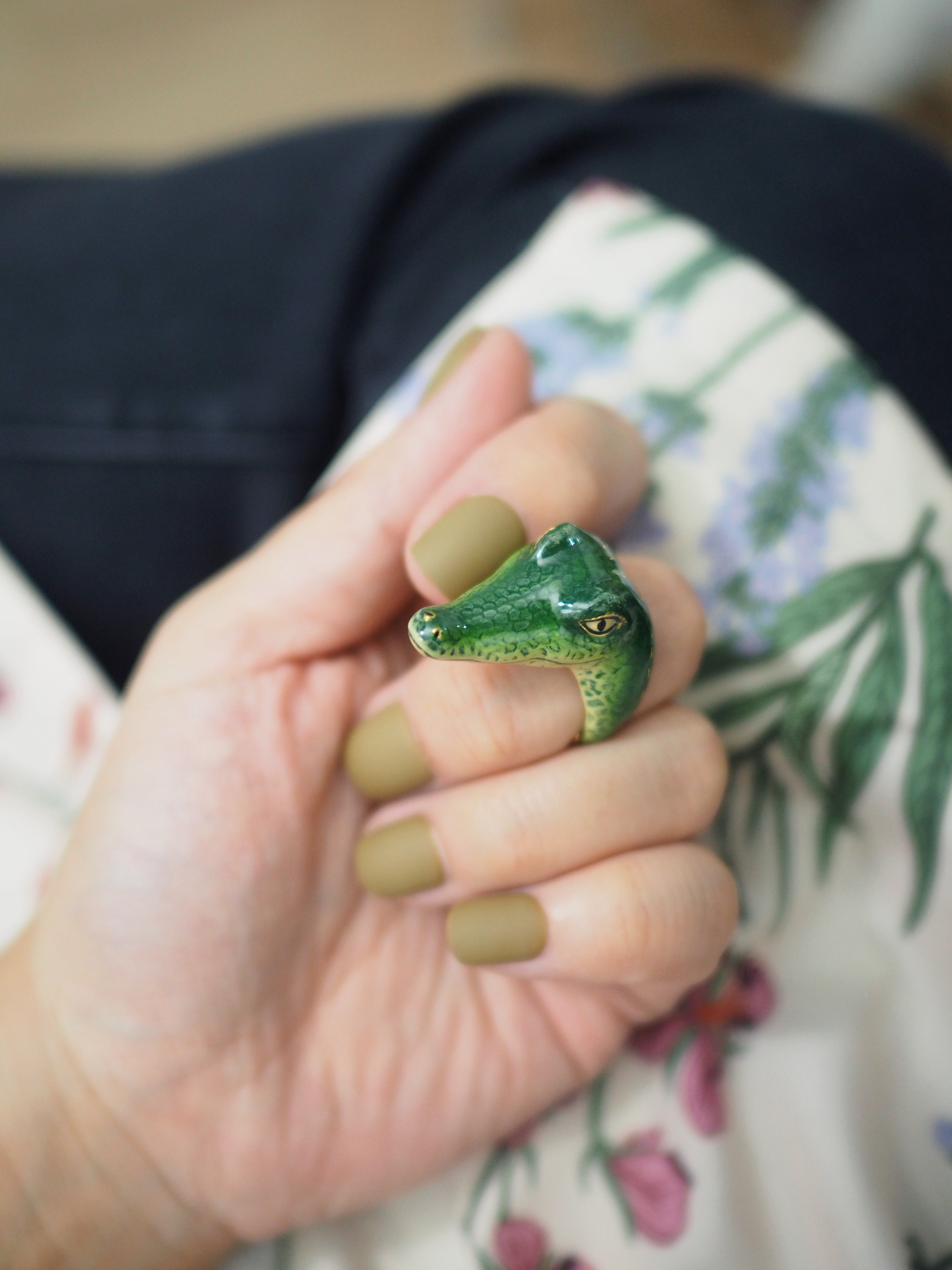 Close-up of a unique crocodile ring on a hand