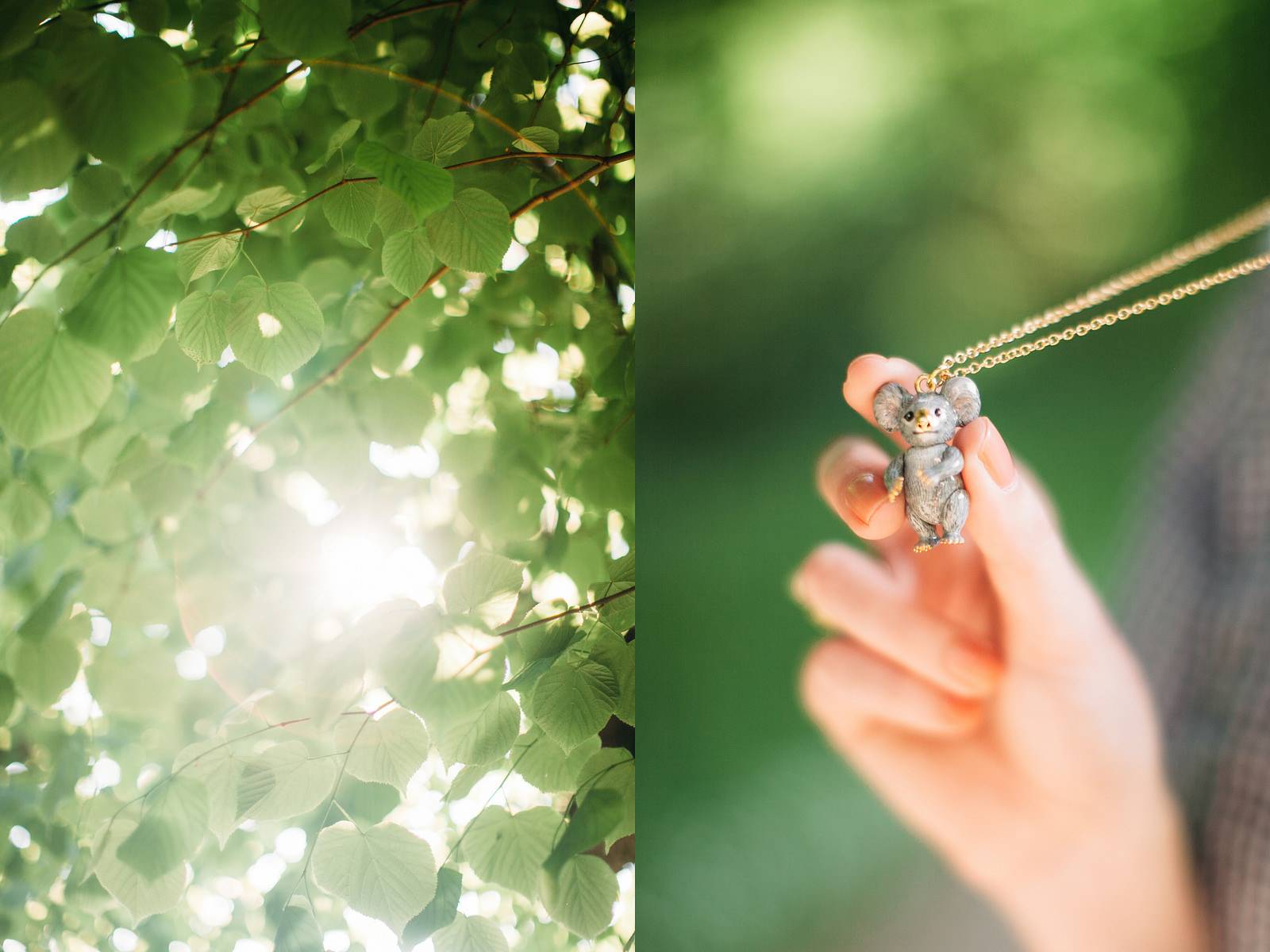 A close-up of vibrant green leaves with sunlight peeking through, beside a hand holding a small koala pendant necklace.