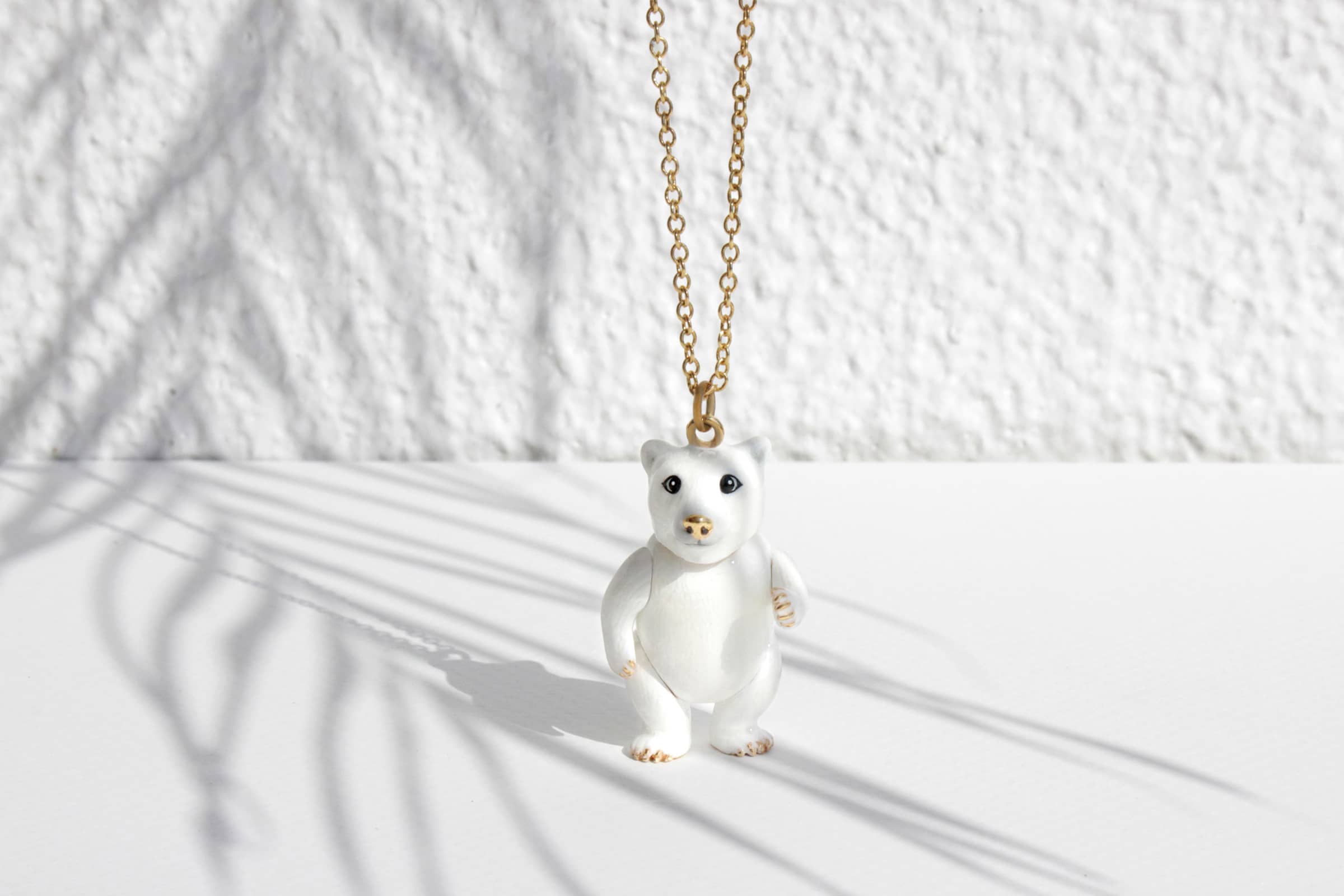 Adorable polar bear pendant necklace set in the white background.