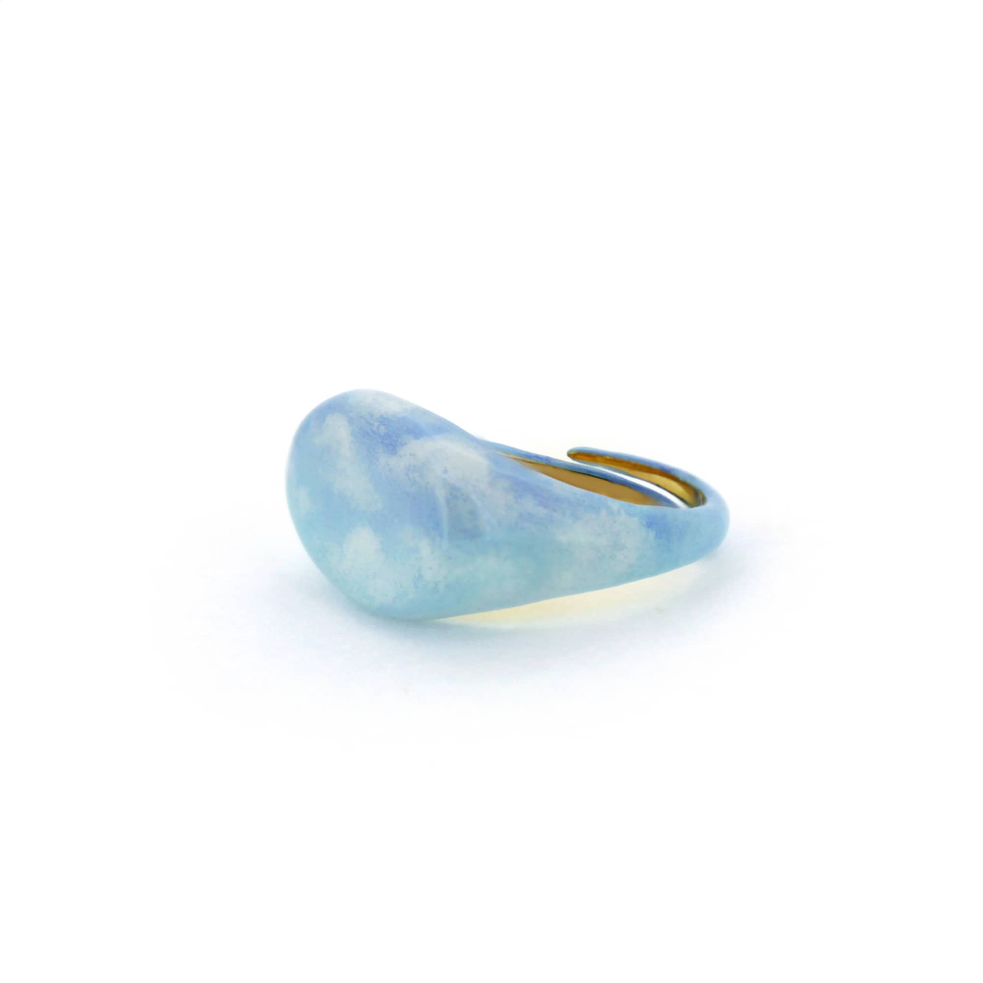 A beautiful hand-painted ring inspired by the sky with soft blue tones.