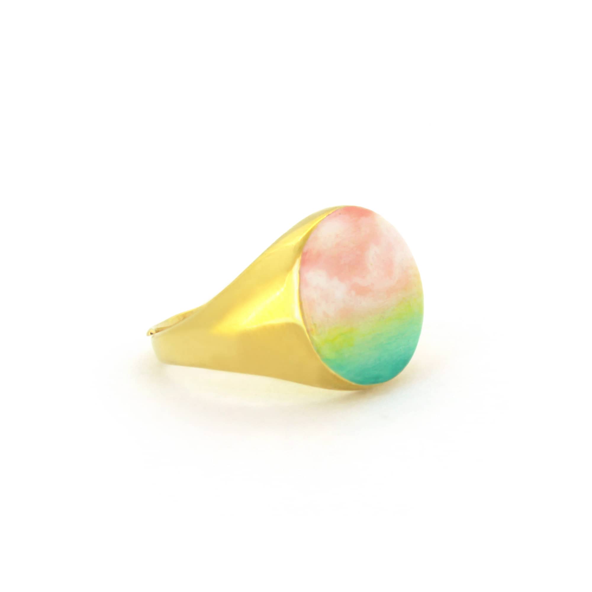 A beautiful hand-painted ring inspired by a colorful dawn with pink and green hues.