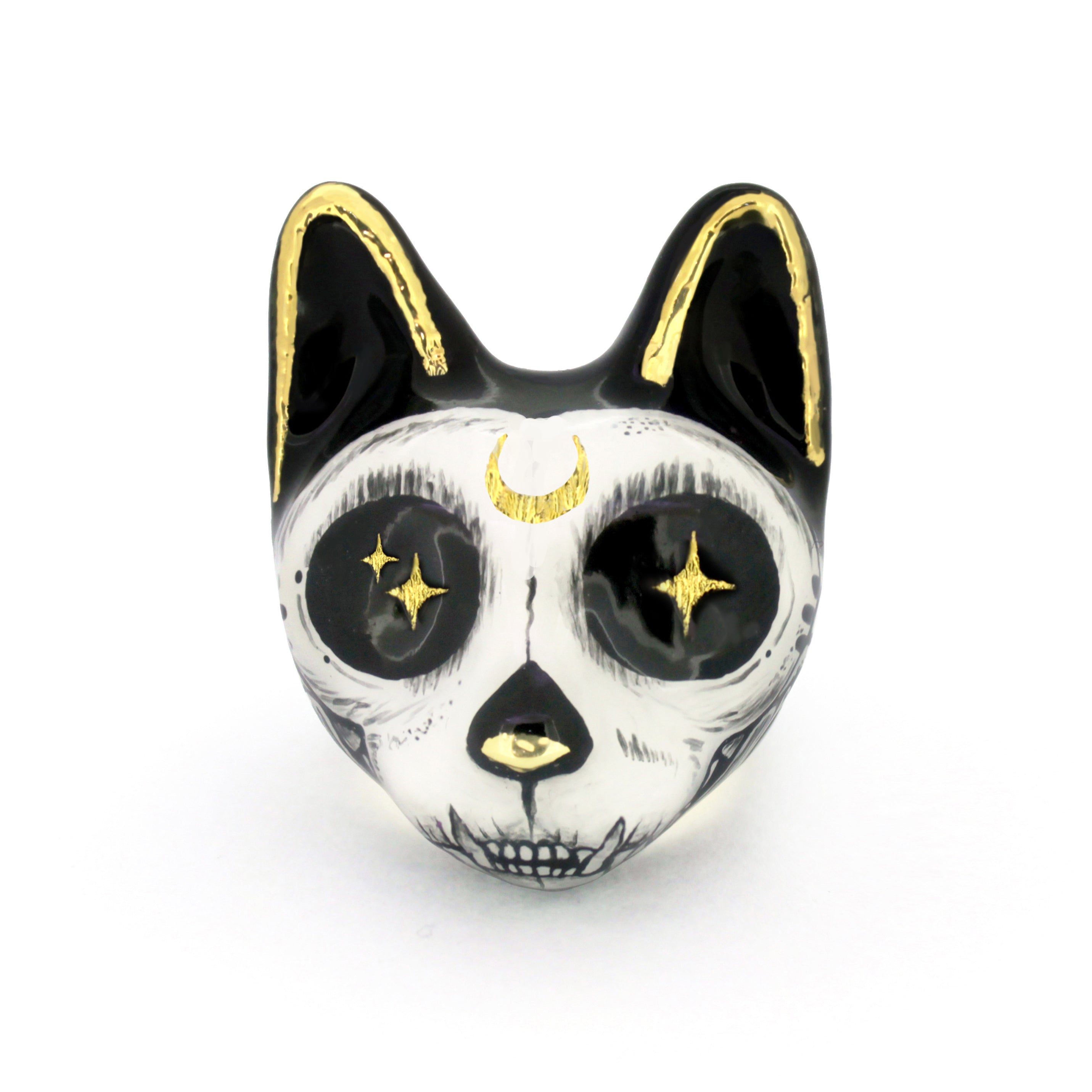 An artistic cat ring designed with a skull motif, featuring black and white colors with gold accents and starry eyes.