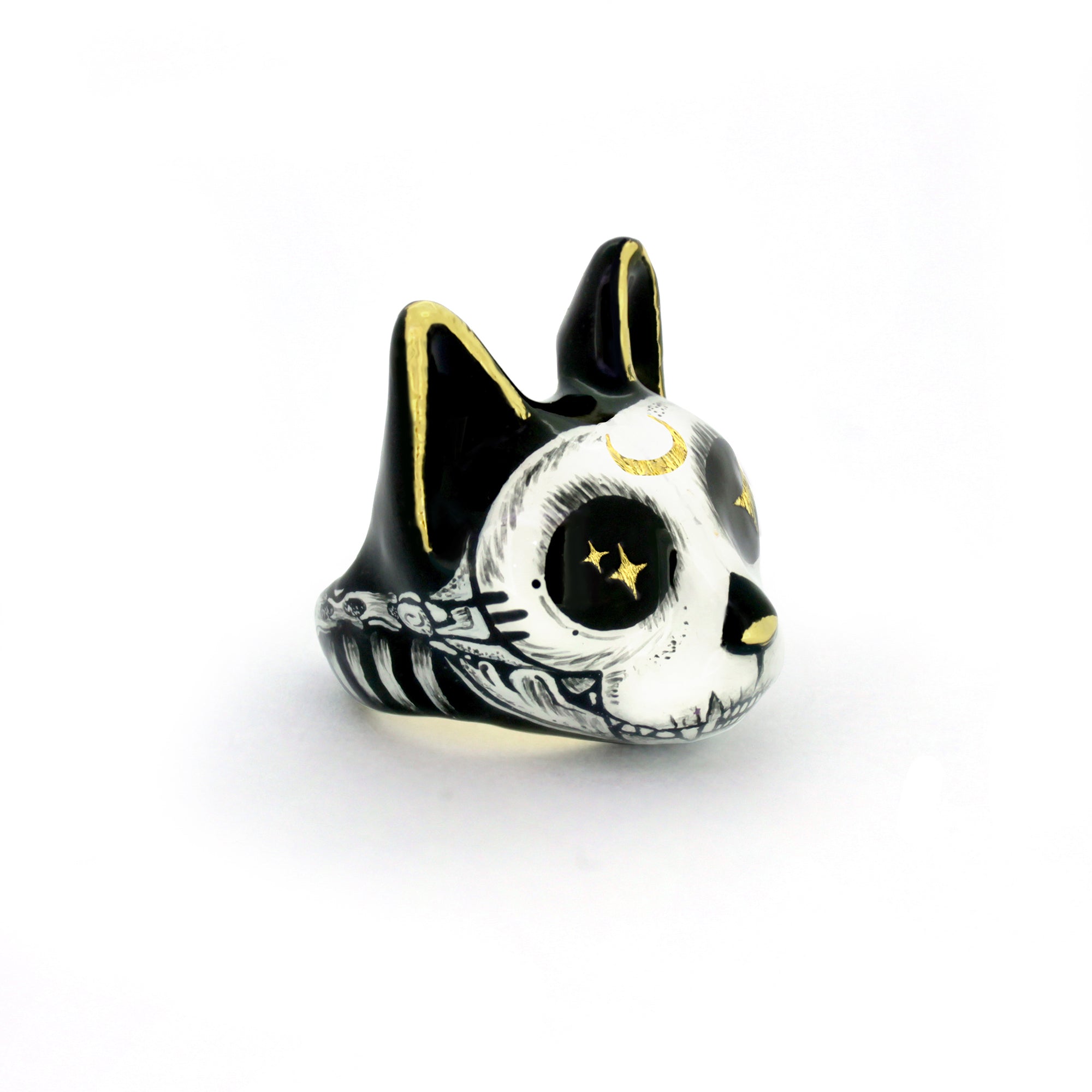 Black and white cat ring featuring a skull design with gold accents and starry eyes, ideal for Halloween costume.