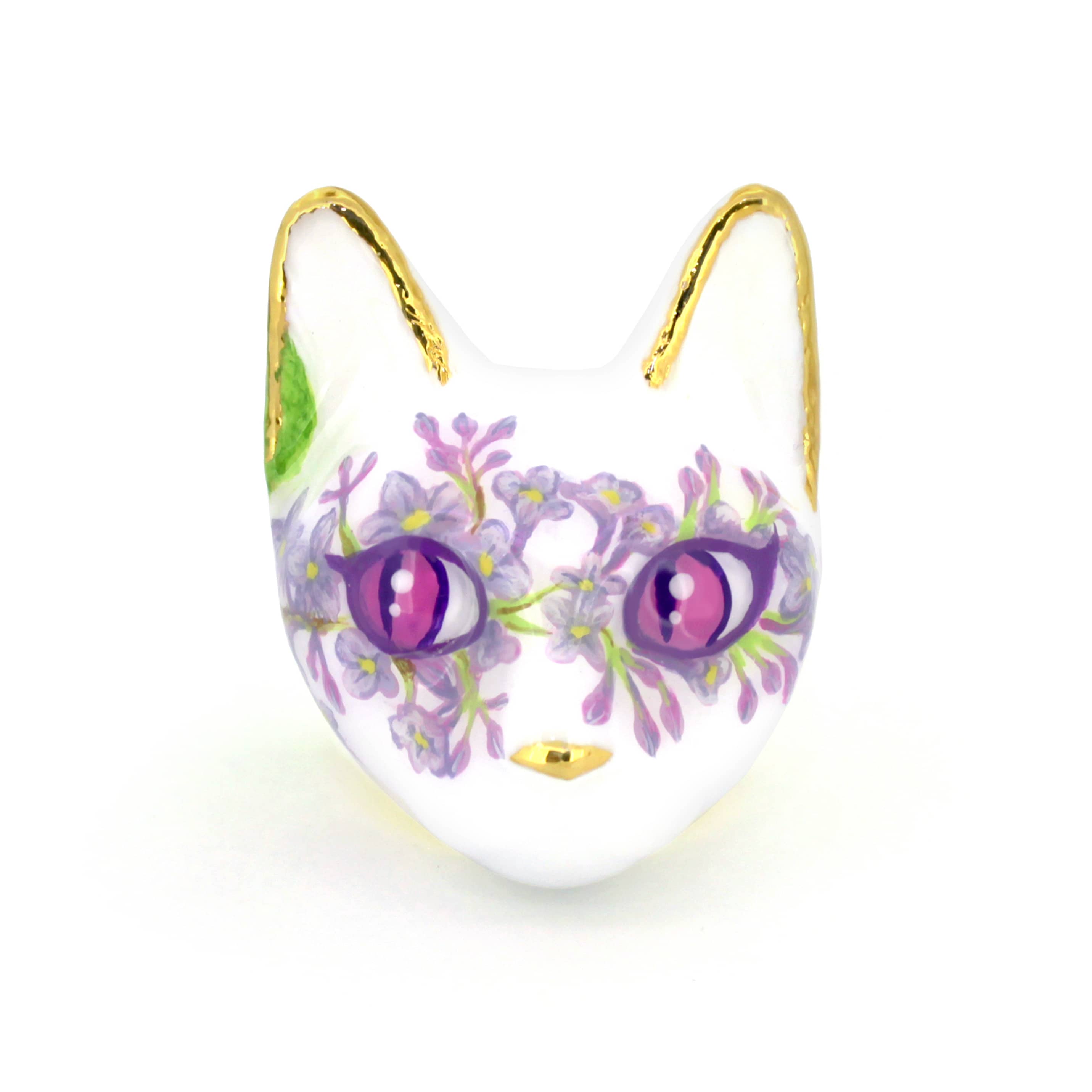 A beautiful cat head ring with purple flower designs, sparkling gold accents, and large, expressive purple eyes.