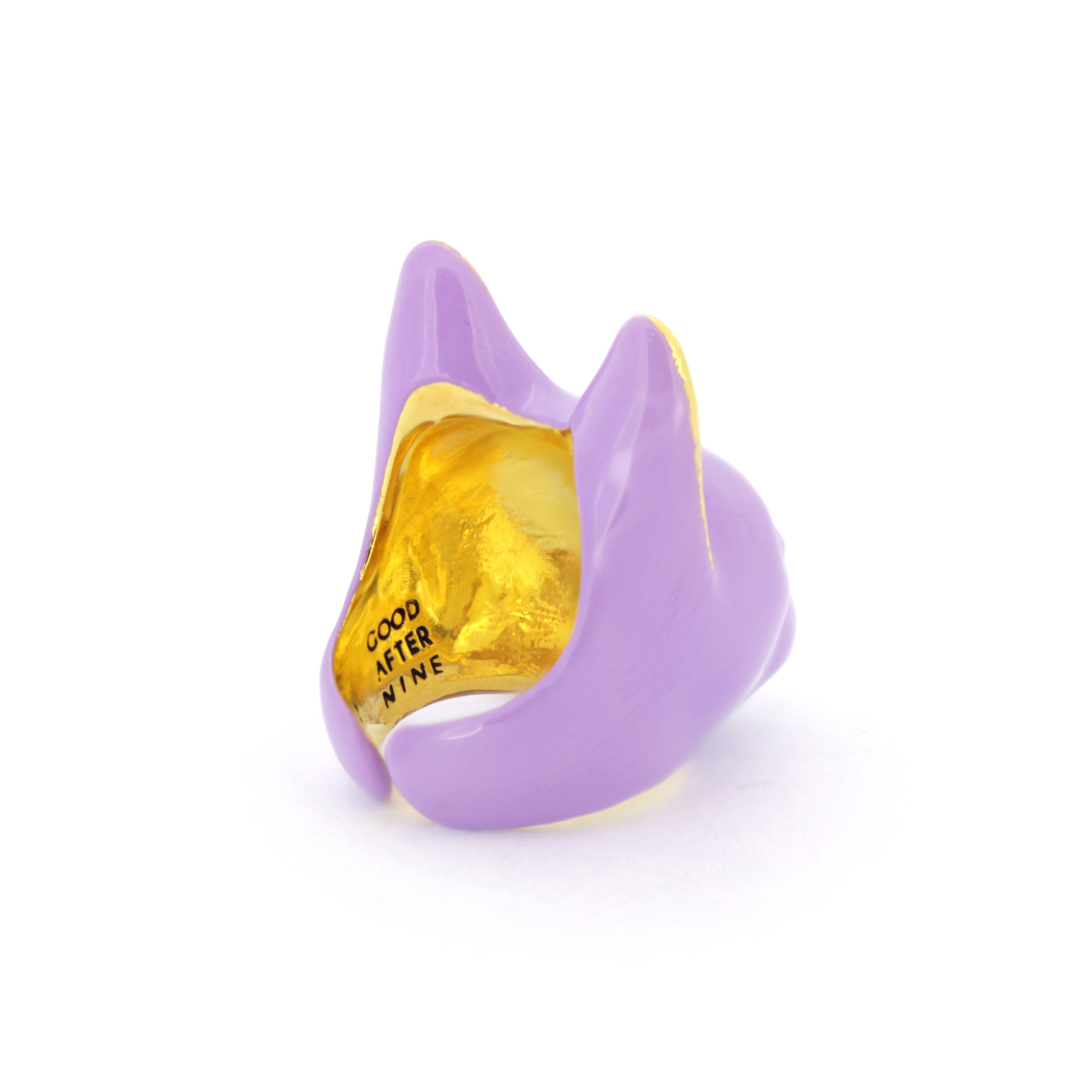 A purple cat face ring with gold accents on the ears and a small gold nose.