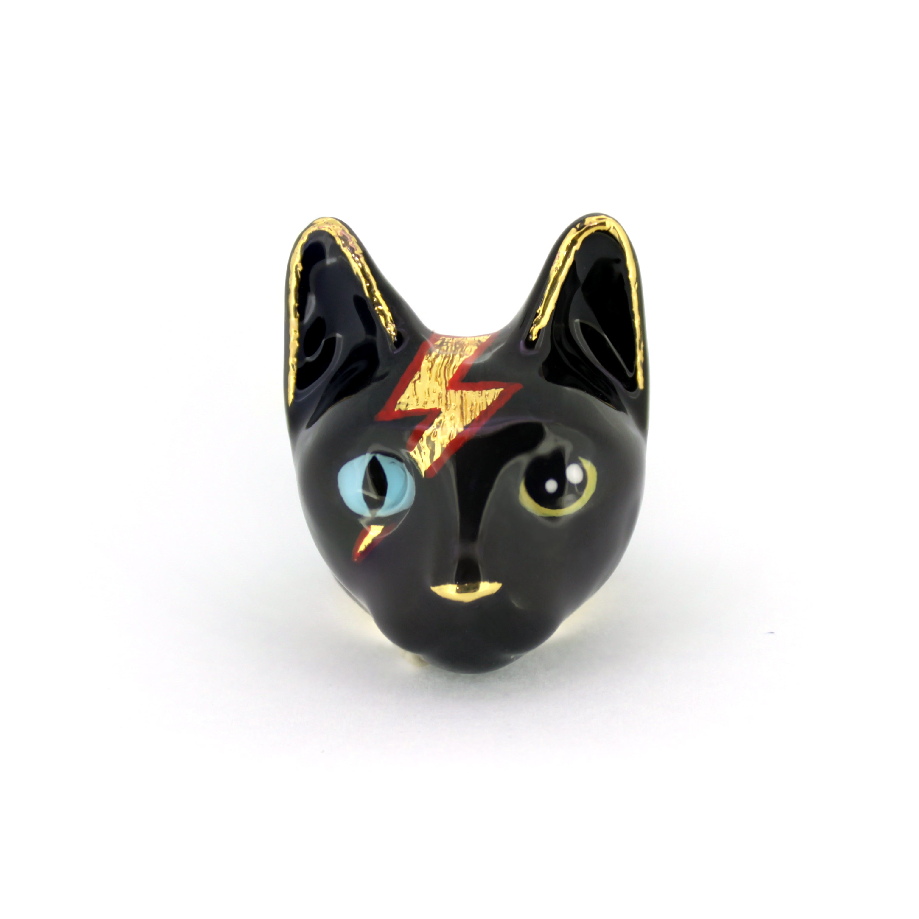 A playful black cat ring with blue and yellow eyes and a lightning bolt design.