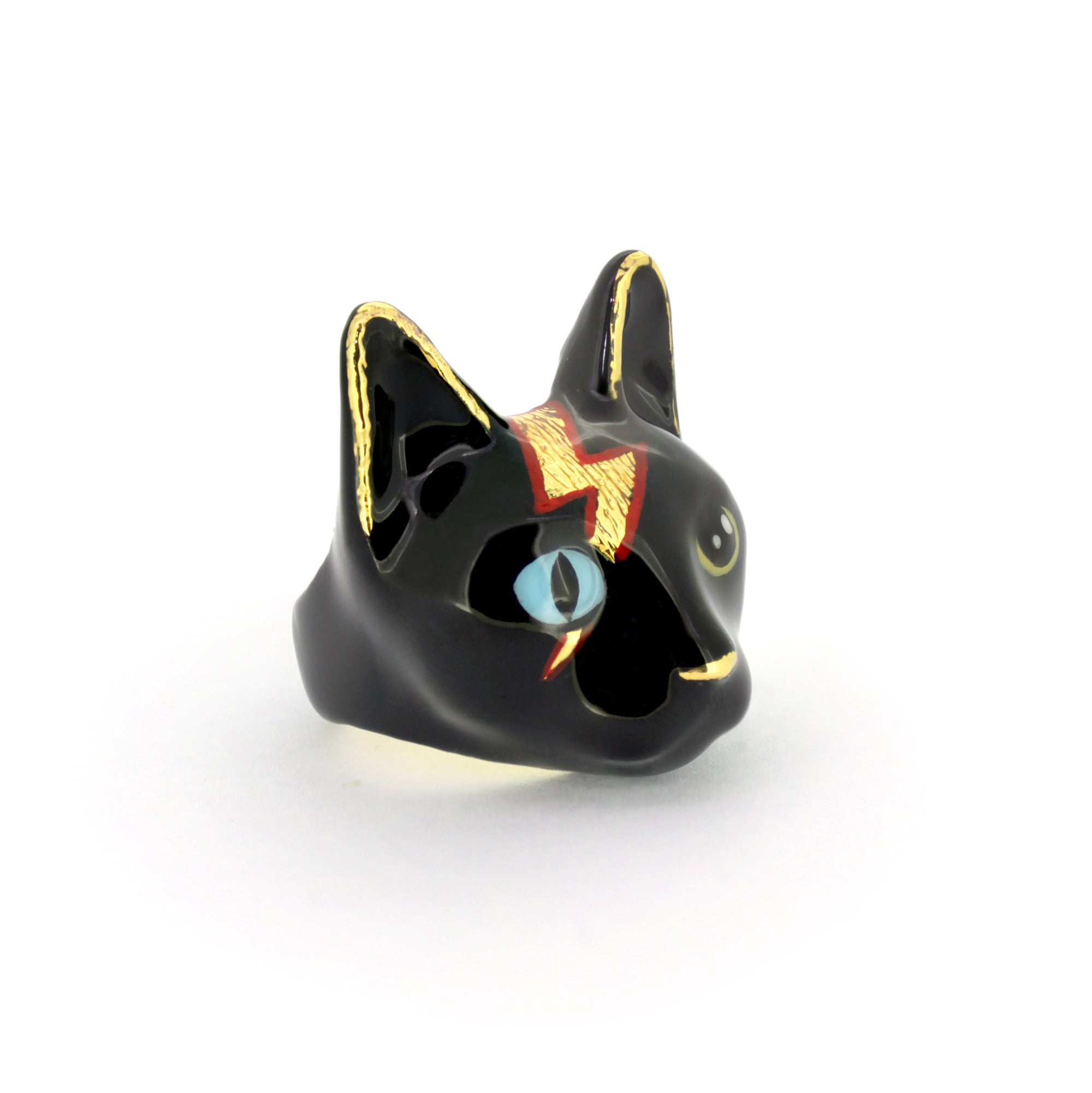 A playful black cat ring with blue and yellow eyes and a lightning bolt design.