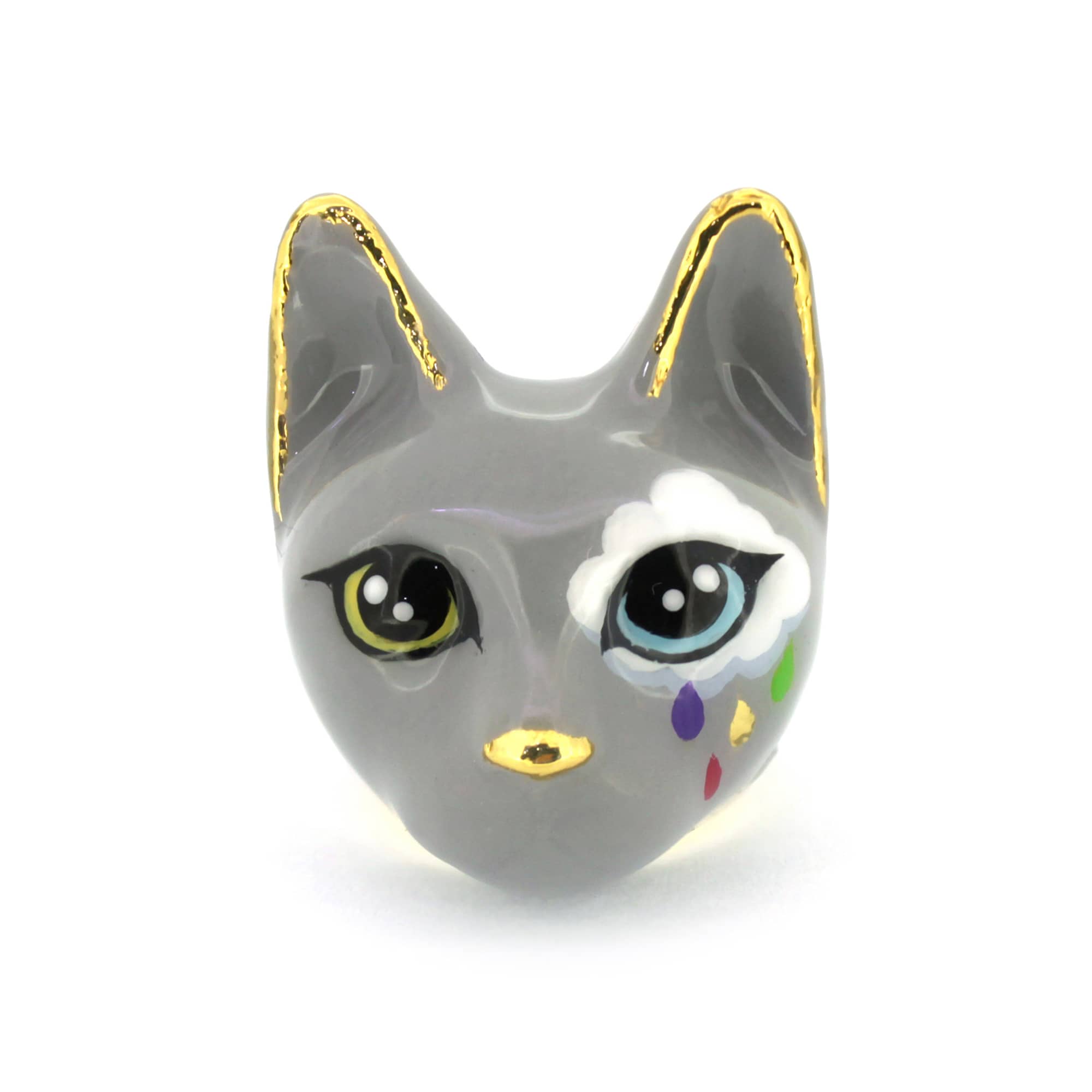 Whimsical cat ring in grey, with large yellow and light blue eyes and a white cloud painted on one side, with colorful raindrops.