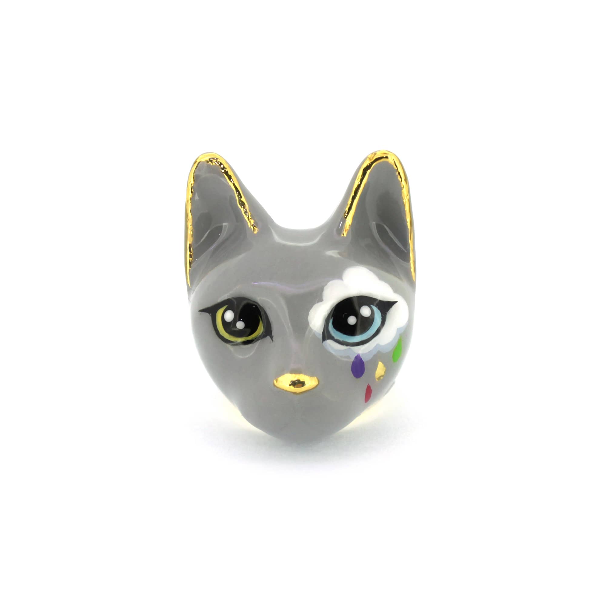 Whimsical cat ring in grey, with large yellow and light blue eyes and a white cloud painted on one side, with colorful raindrops