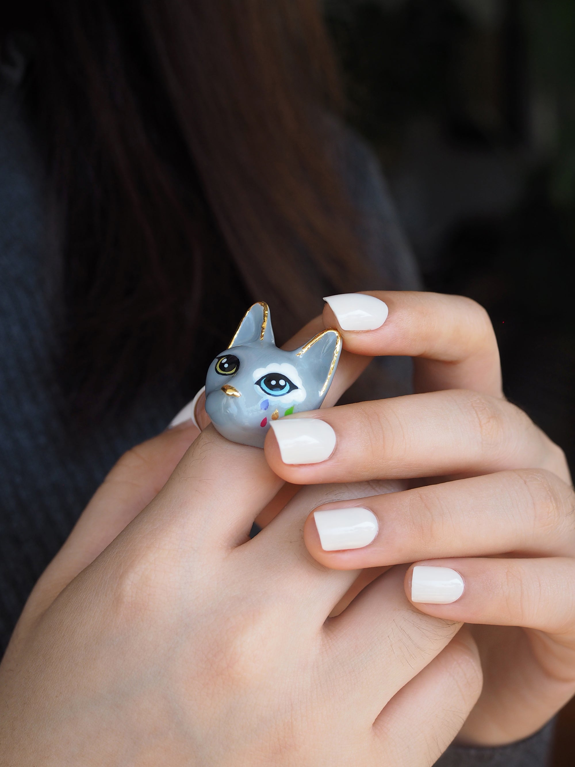 Playful cat jewelry featuring a unique ring design worn on a hand, perfect for cat lovers.