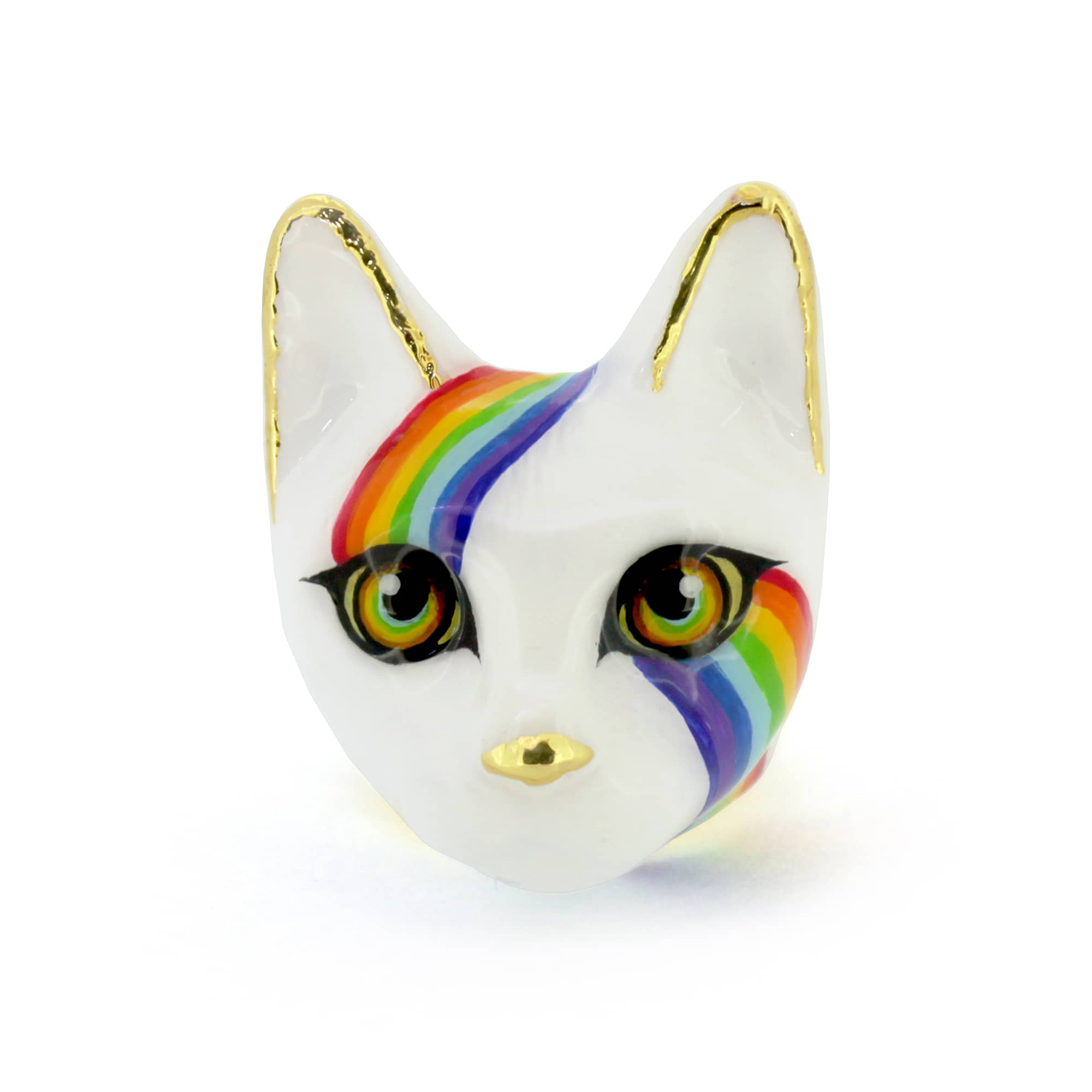 A whimsical ring designed as a cat's face, featuring a white base, vibrant rainbow stripes across the forehead and cheek and and large eyes.