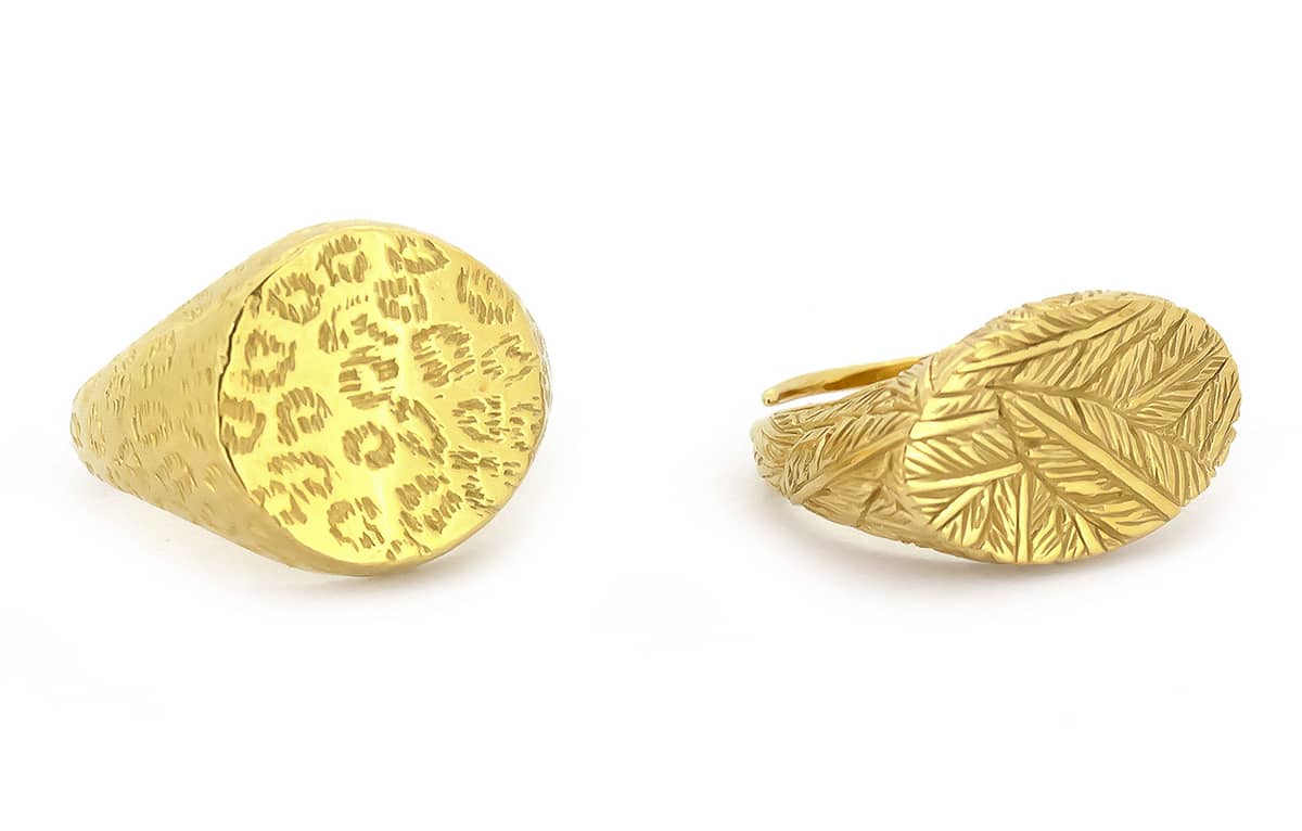 Two gold rings with distinct textures, one featuring a leopard print and the other a feather pattern.