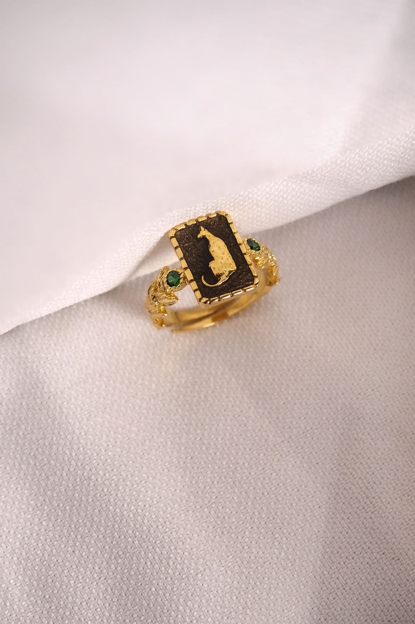 Unique golden ring with a leopard design and vibrant decorative stones.