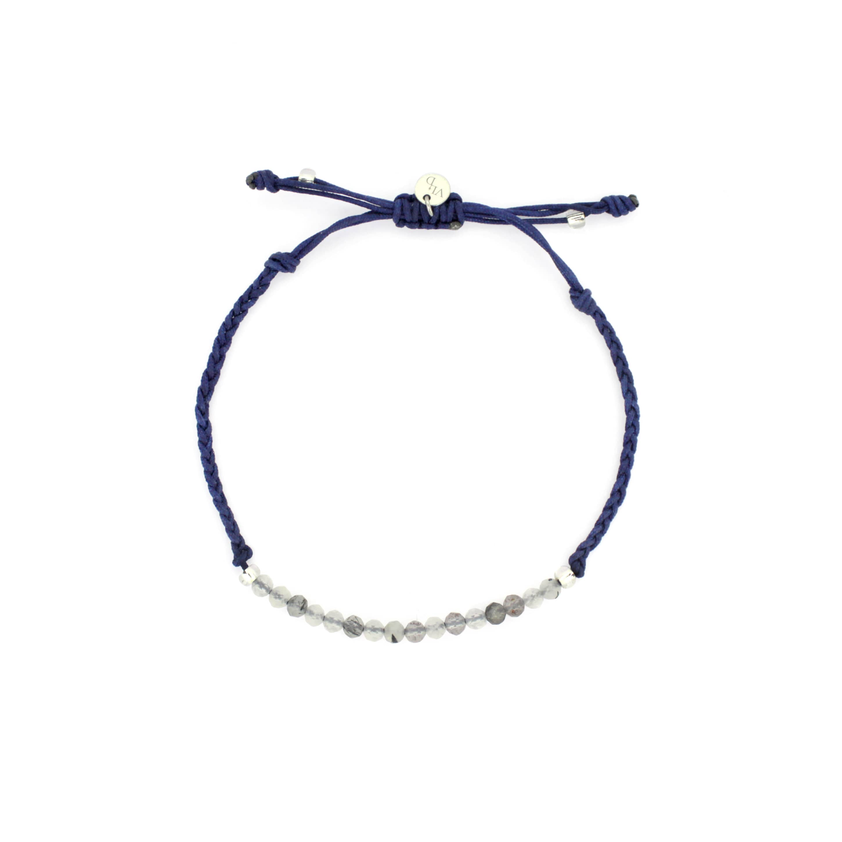 A navy blue bracelet with grey quartz-faced beads