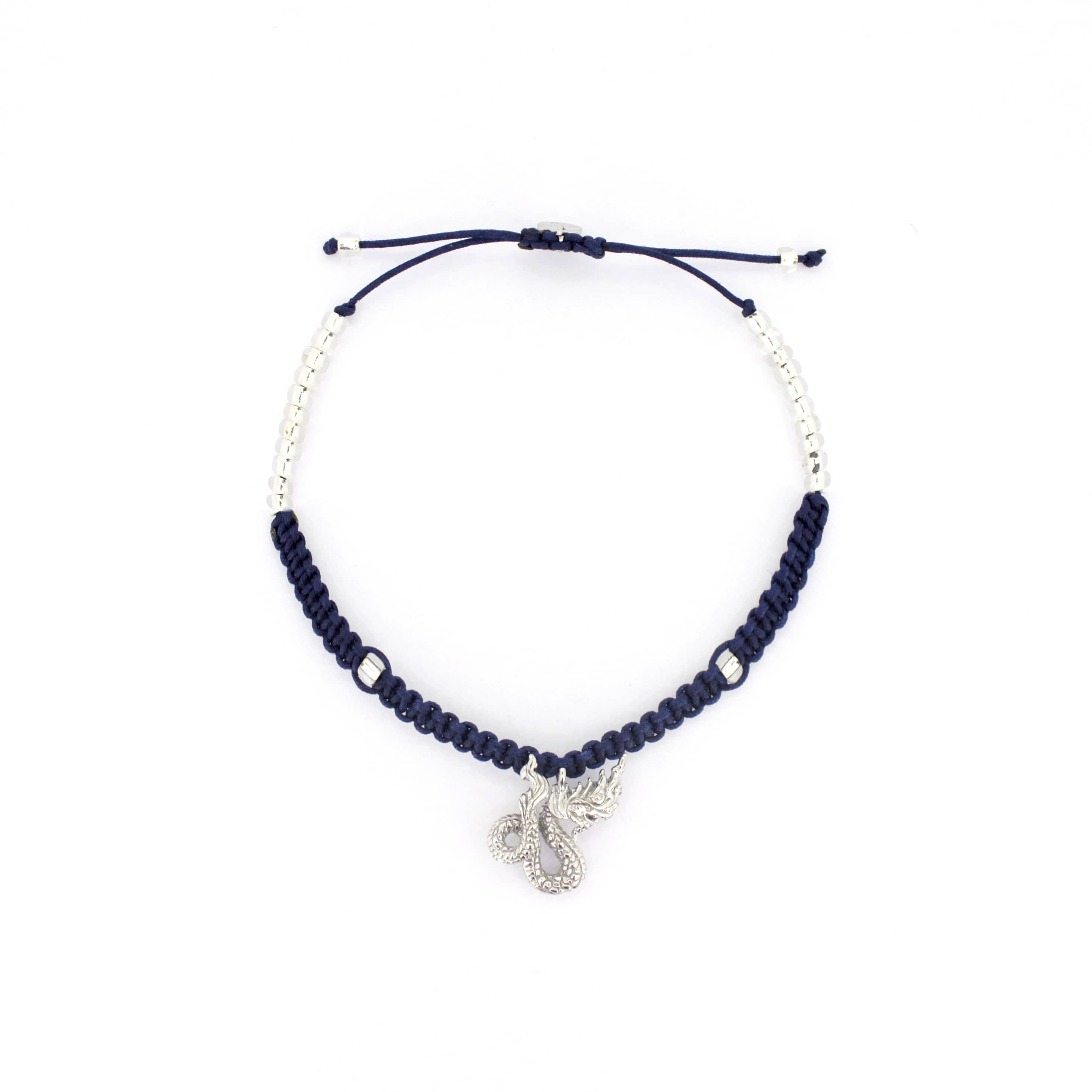 A navy blue bracelet with a silver Naga charm