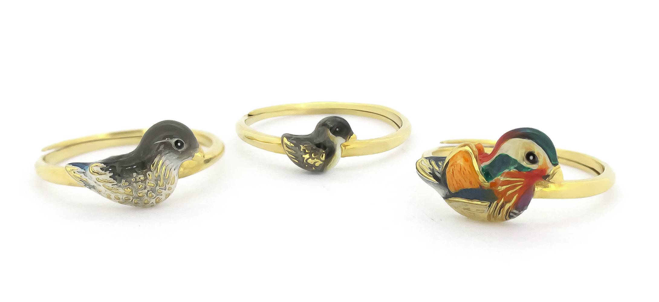 A set of three gold rings featuring colorful, intricately designed mandarin duck motifs in varying sizes.