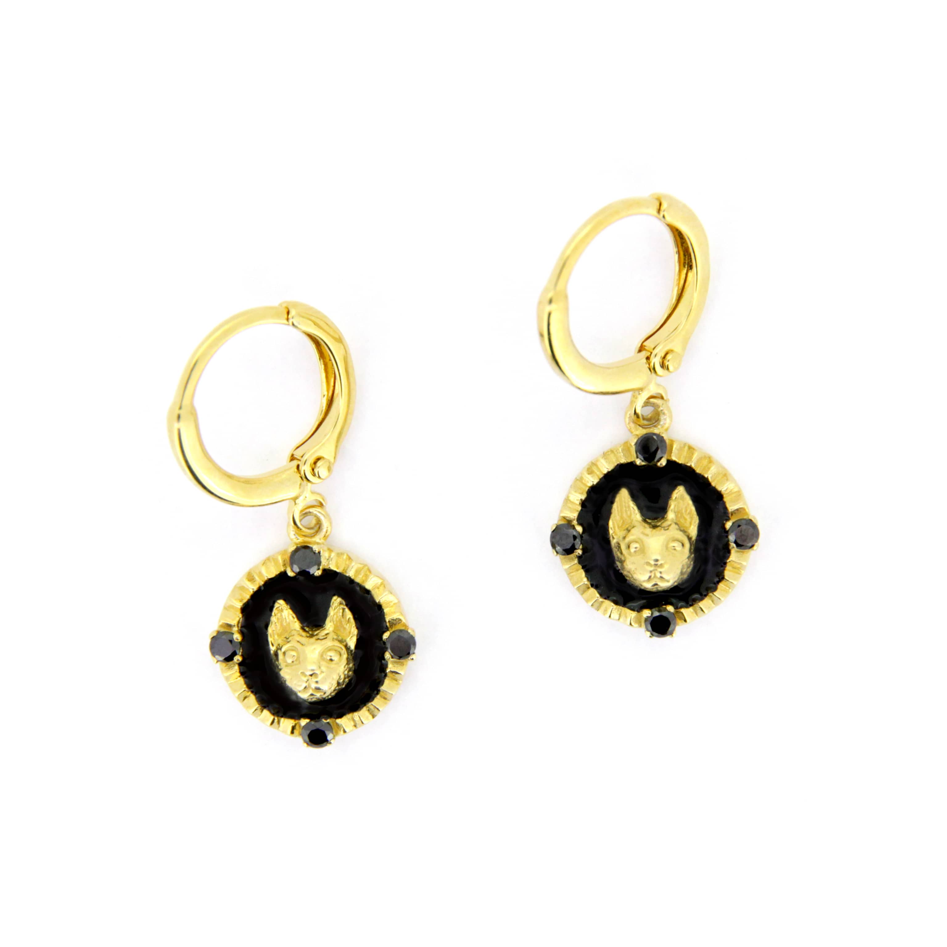 Gold earrings featuring a cat face motif surrounded by a black circular design.