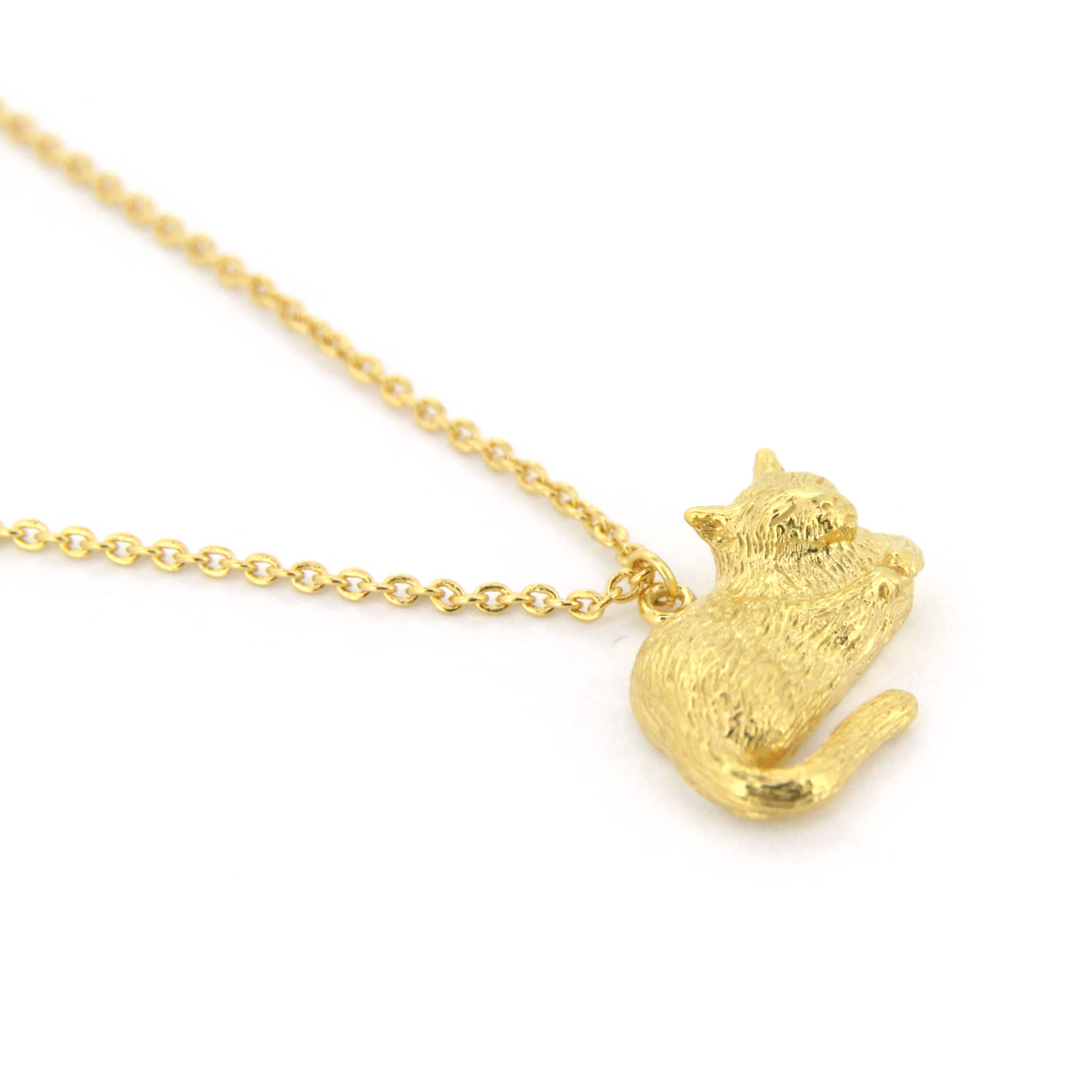 Gold pendant necklace featuring a sleeping cat design, perfect for animal lovers.