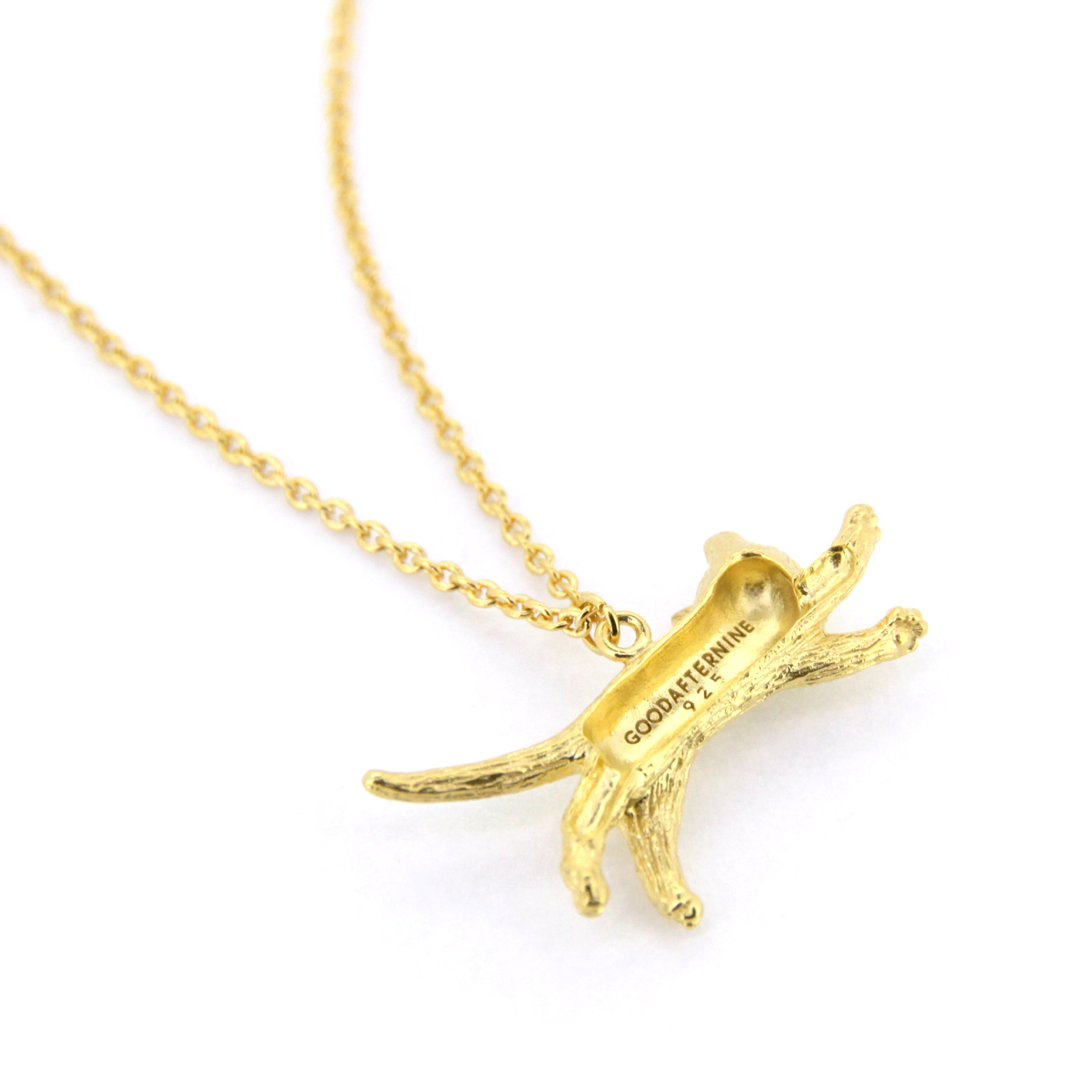 Adorable gold pendant necklace featuring a jumping cat design.