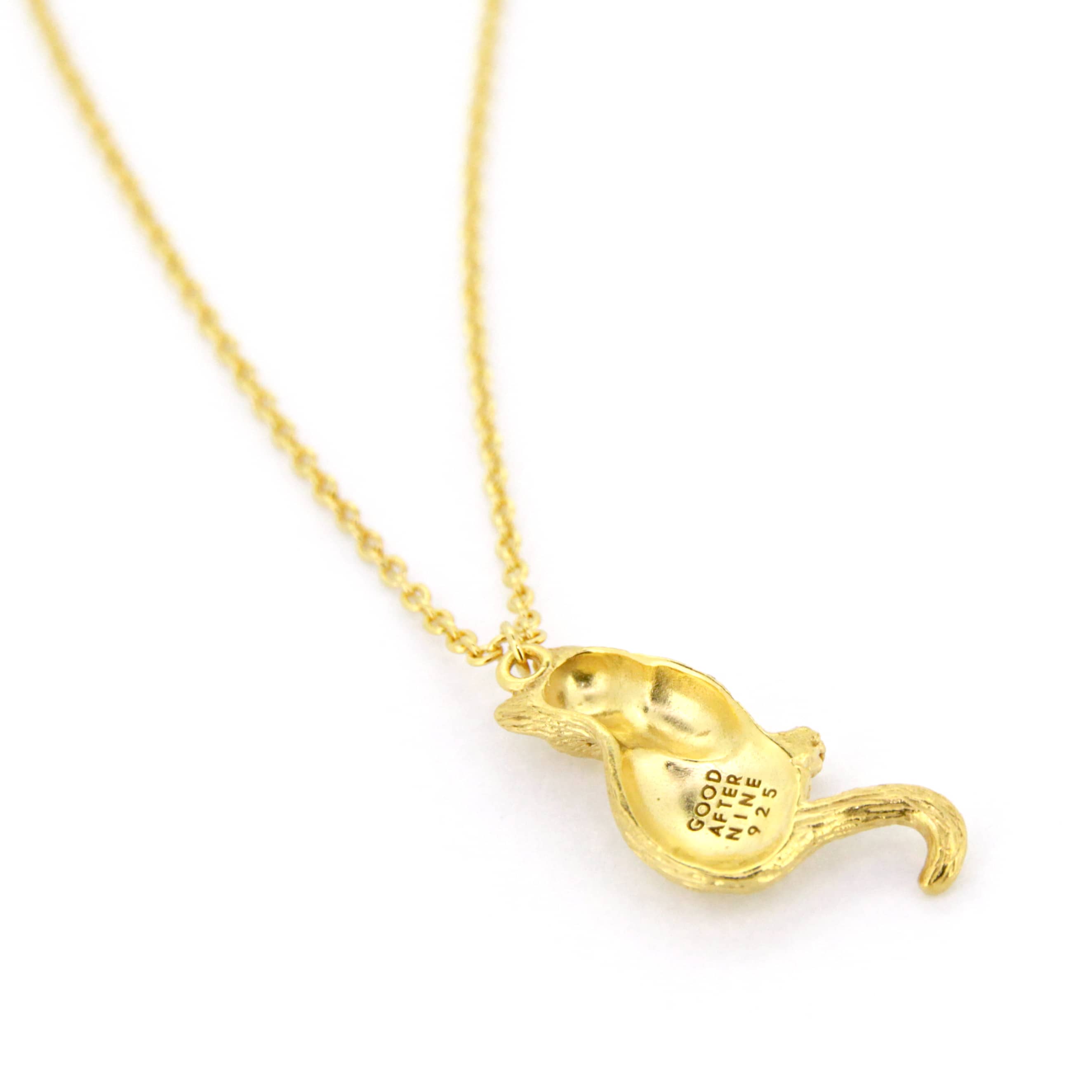 Gold pendant necklace featuring a setting cat design, perfect for animal lovers.