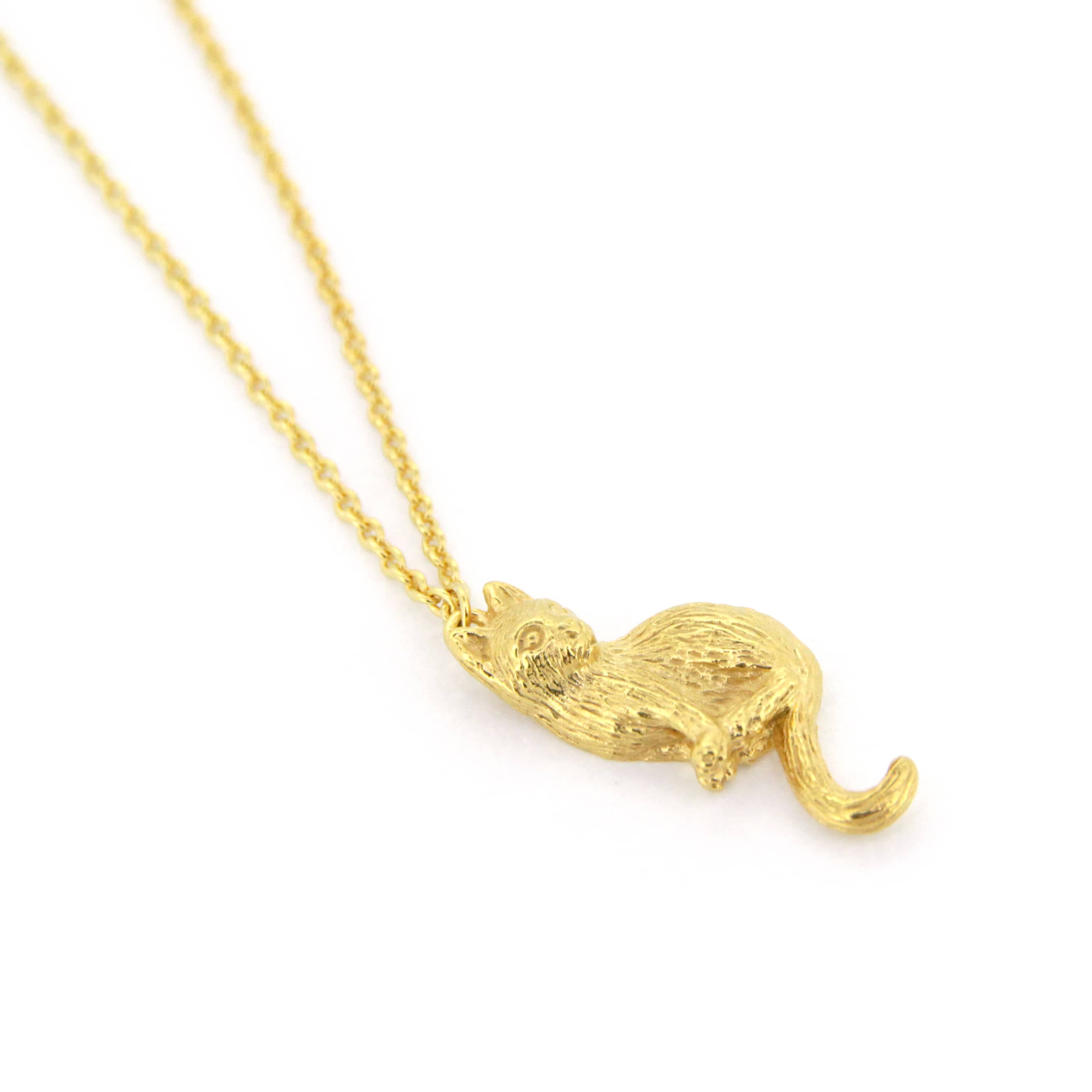 Handcrafted gold pendant necklace featuring a setting cat design, perfect for animal lovers.