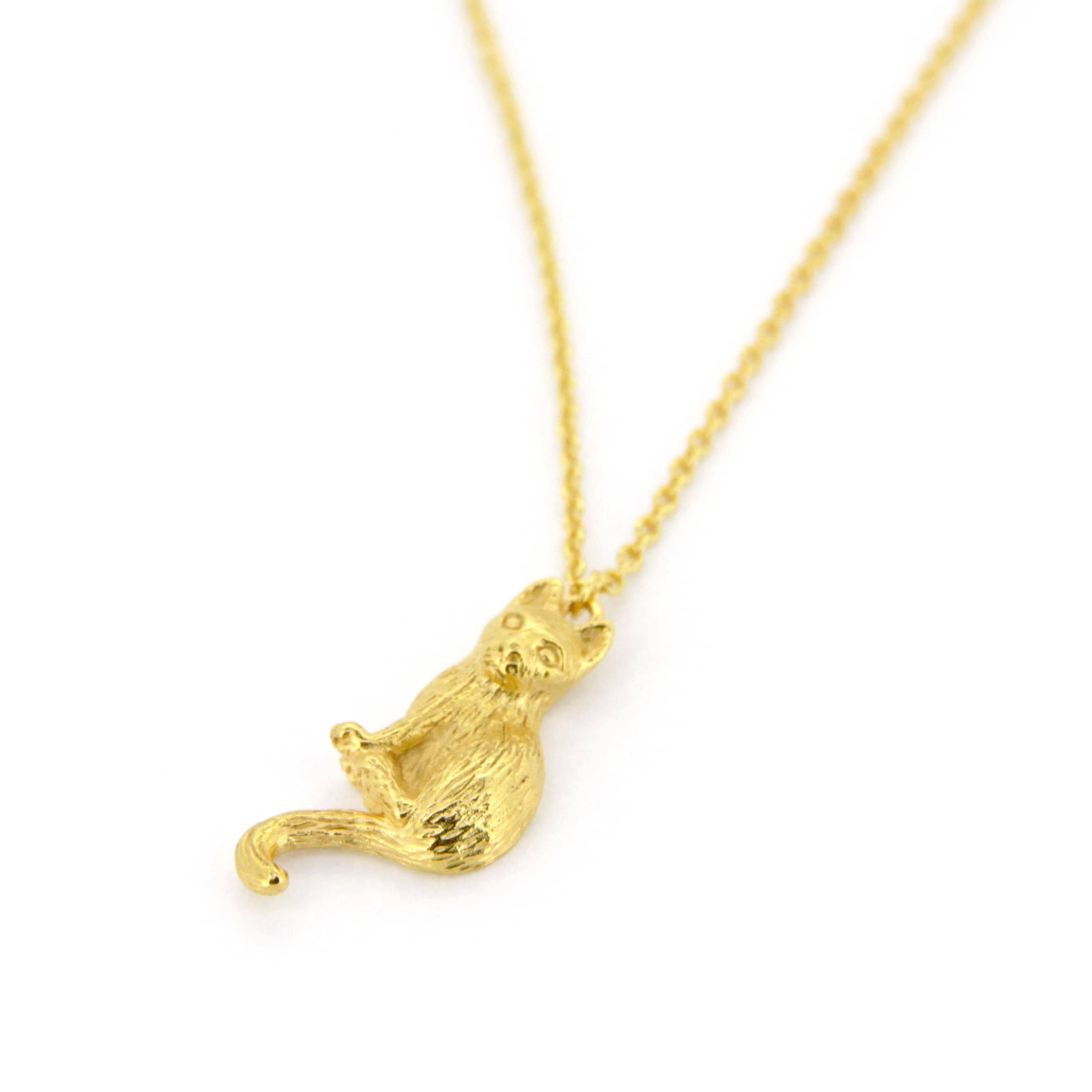 Elegant gold pendant necklace featuring a setting cat design, perfect for animal lovers.