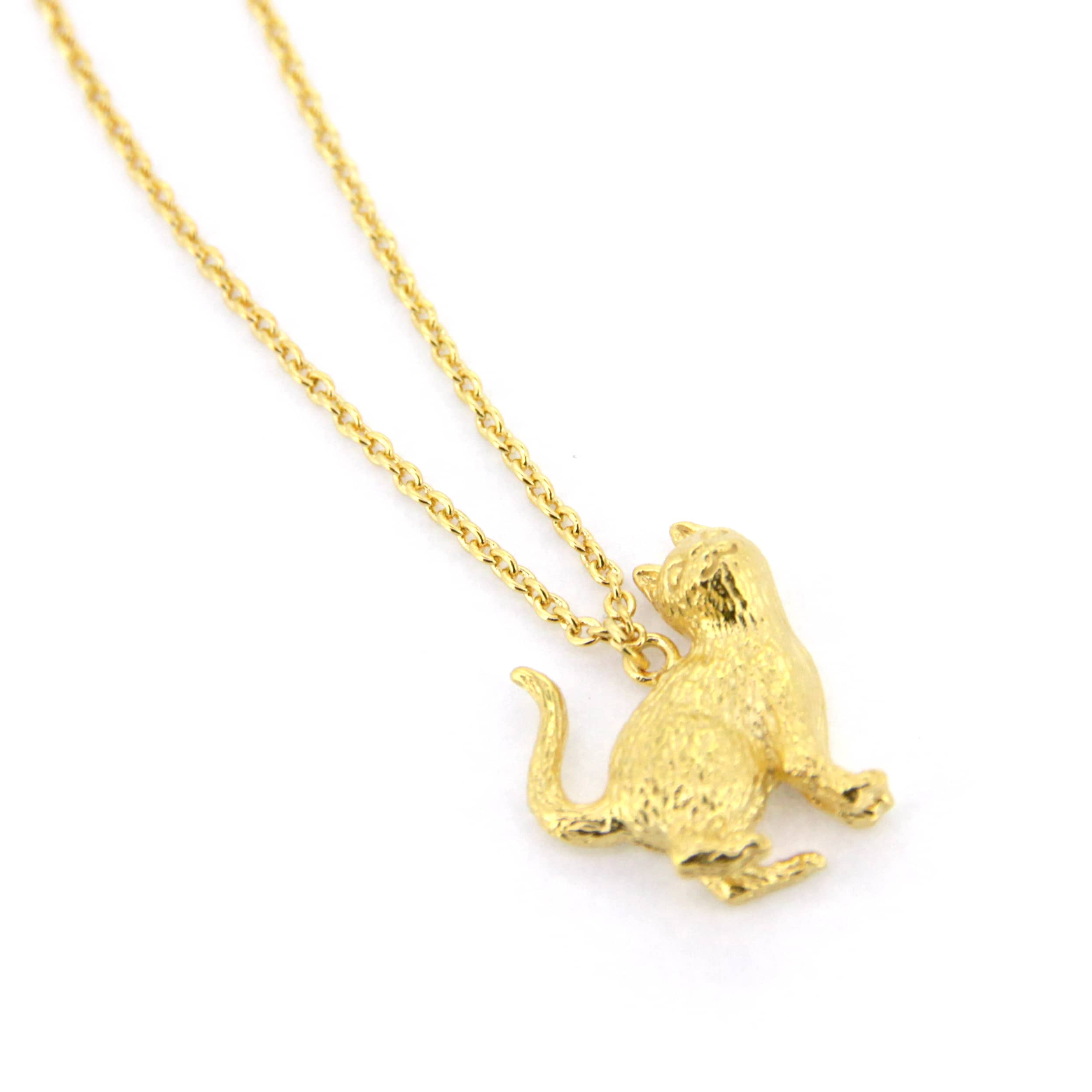 A whimsical gold pendant necklace featuring a standing up cat design, highlighting the fur's details and facial features.