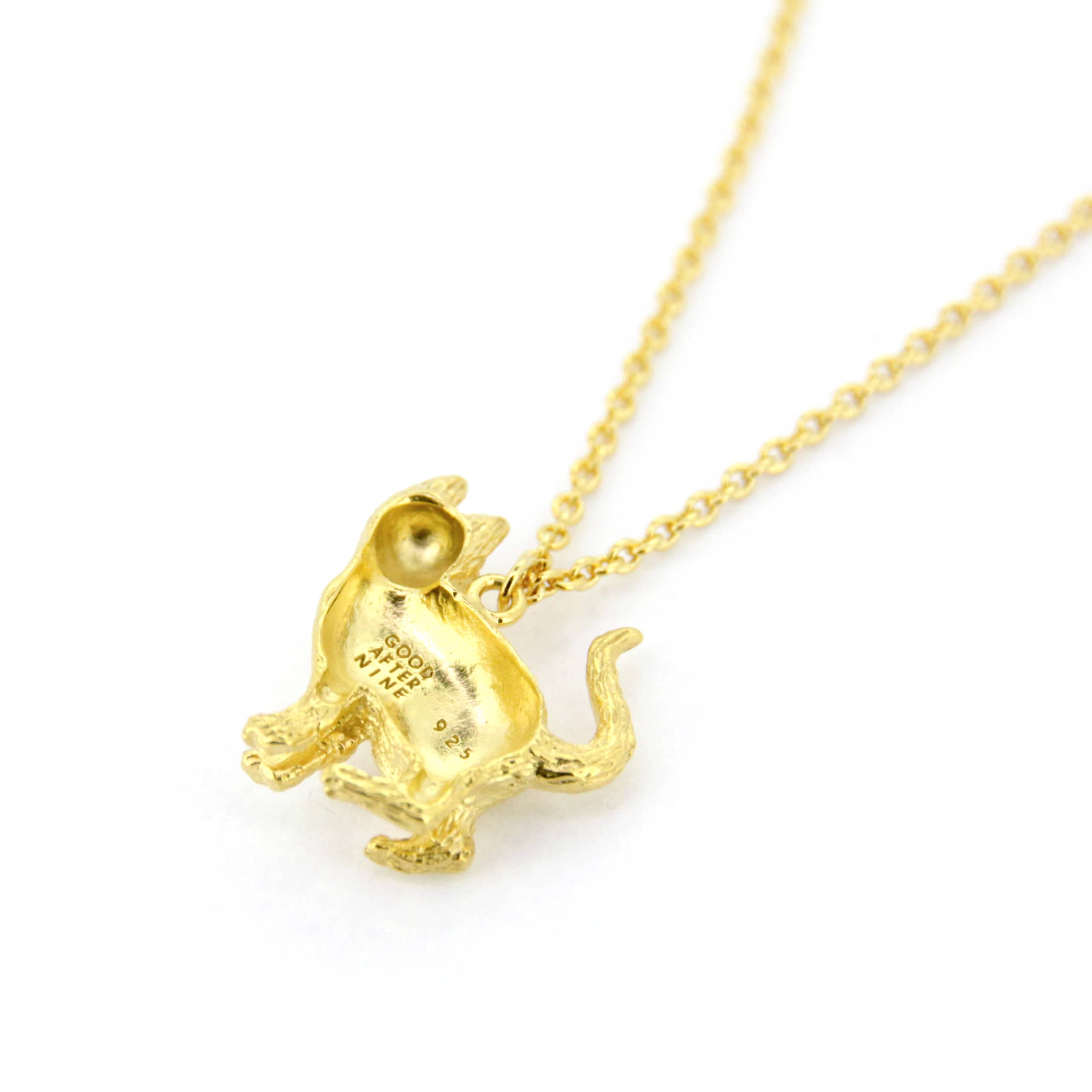 A whimsical gold pendant necklace featuring a standing up cat design, highlighting the fur's details and facial features.