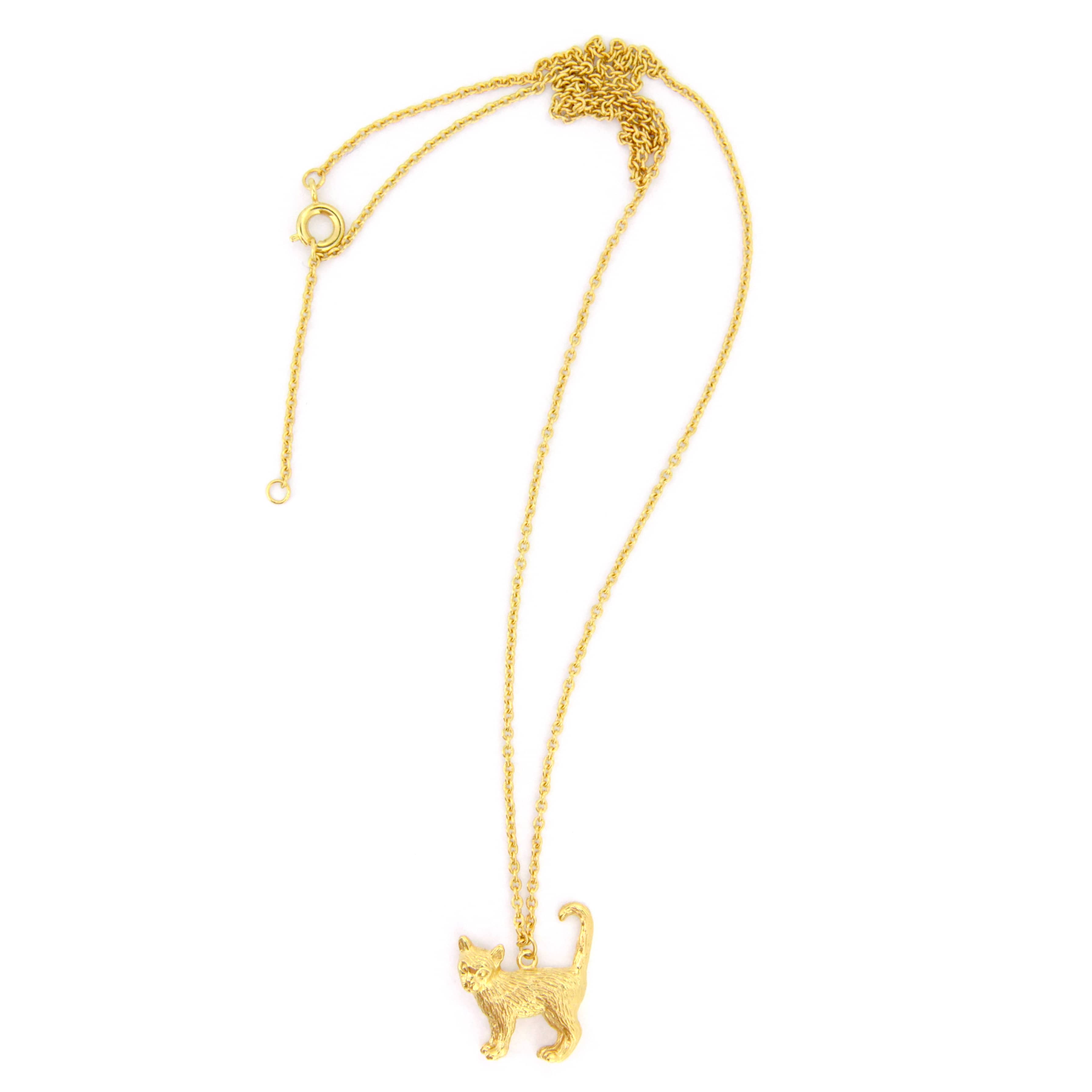 A whimsical gold pendant necklace featuring standing cat design with detailed fur texture.