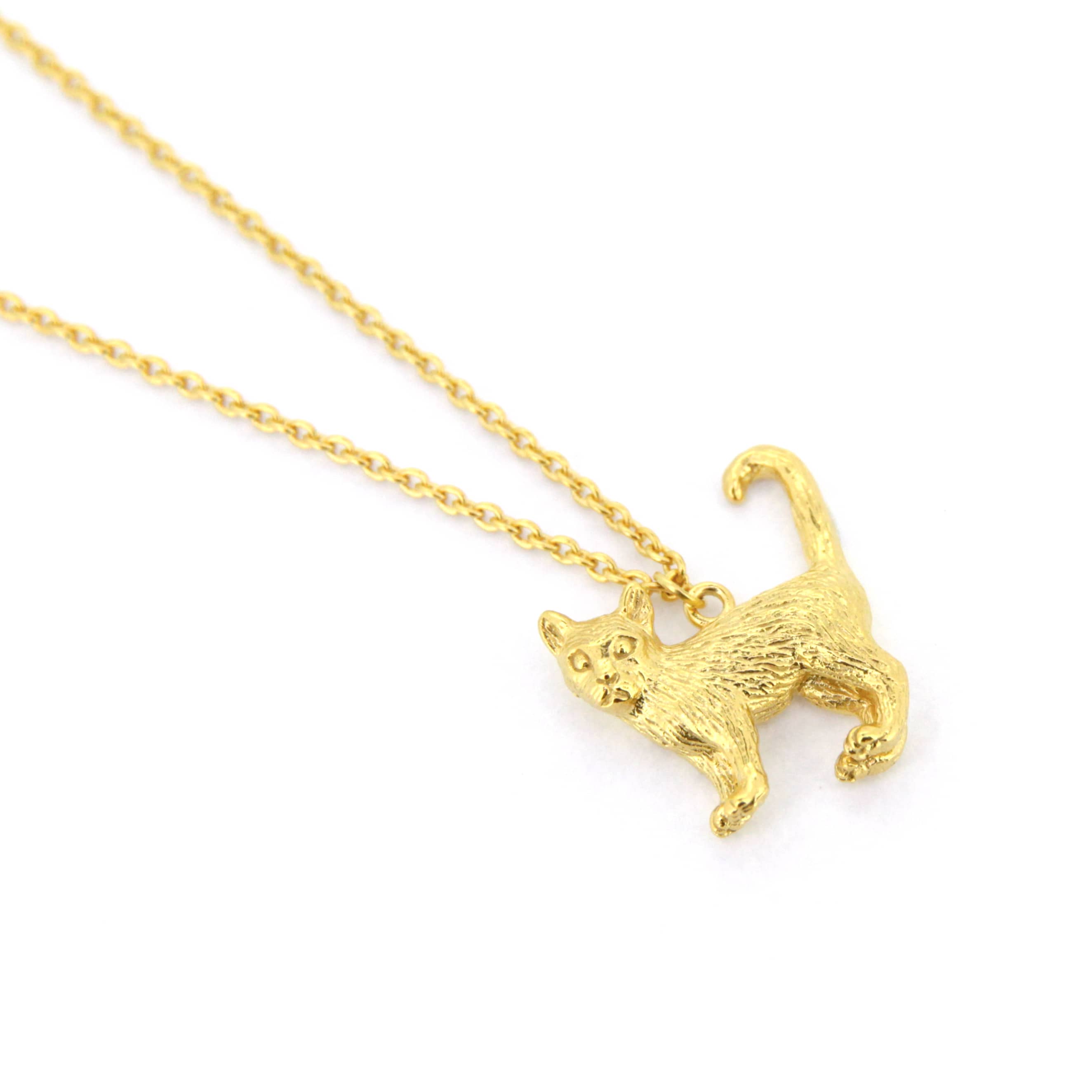 A whimsical gold pendant necklace featuring standing cat design with detailed fur texture.