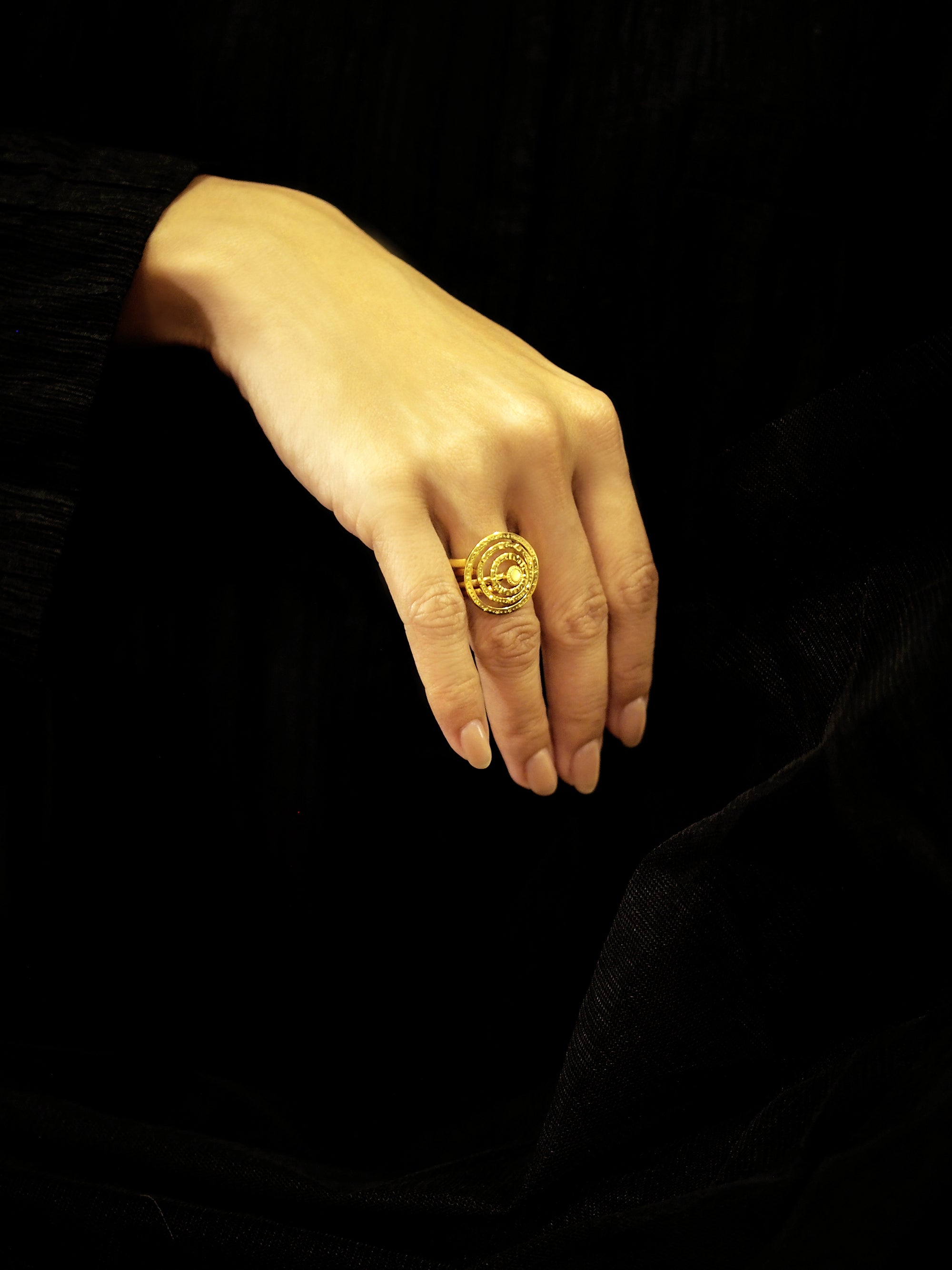 Close-up of a hand wearing gold star-inspired ring set