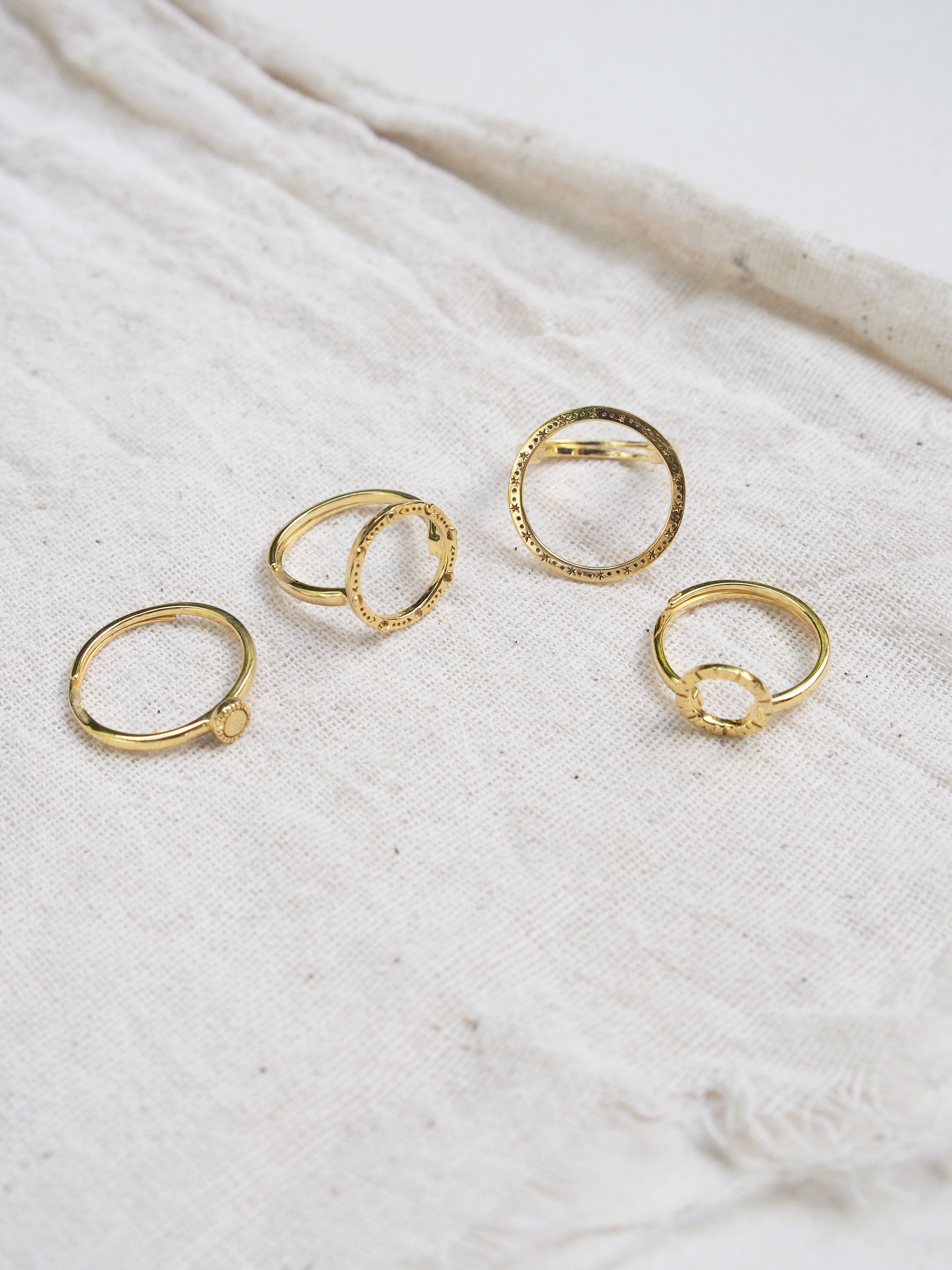 Unique gold ring set inspired by stars and the solar system with intricate design.