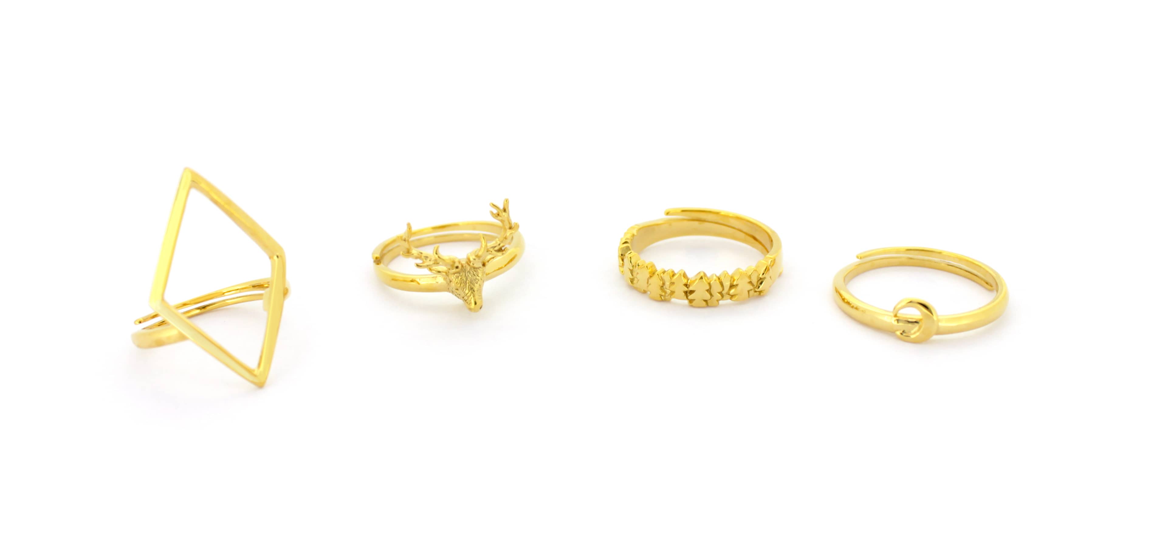 A stunning collection of golden rings featuring unique designs, including the Deer Ring, Forest Ring, Moon Ring, and Rhombus Ring.