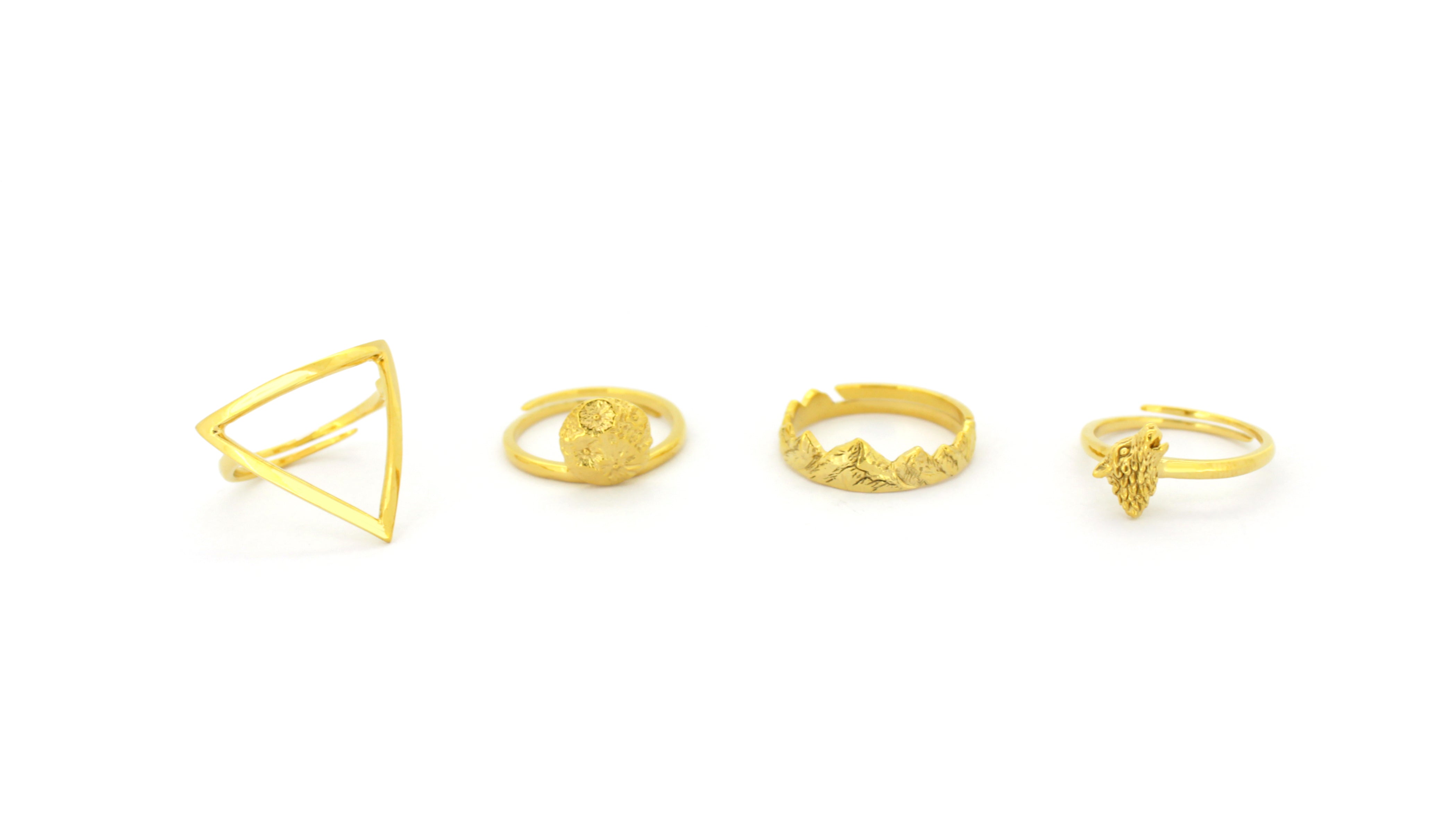 A stunning collection of golden rings featuring unique designs, including the Wolf Ring, Mountain Ring, Moon Ring, and Triangle Ring.