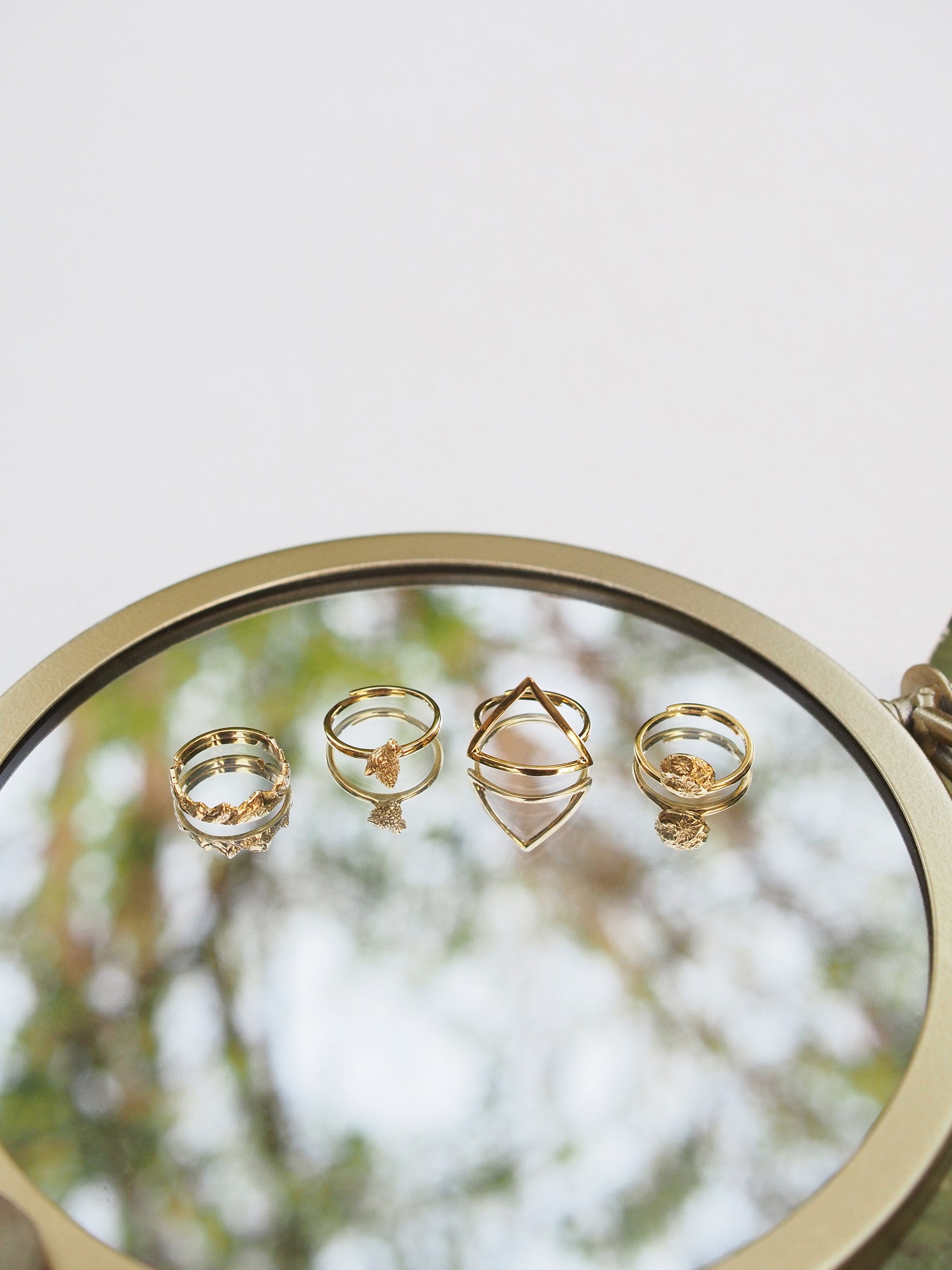 Close-up of a charming wolf stacking ring set reflecting on a mirror