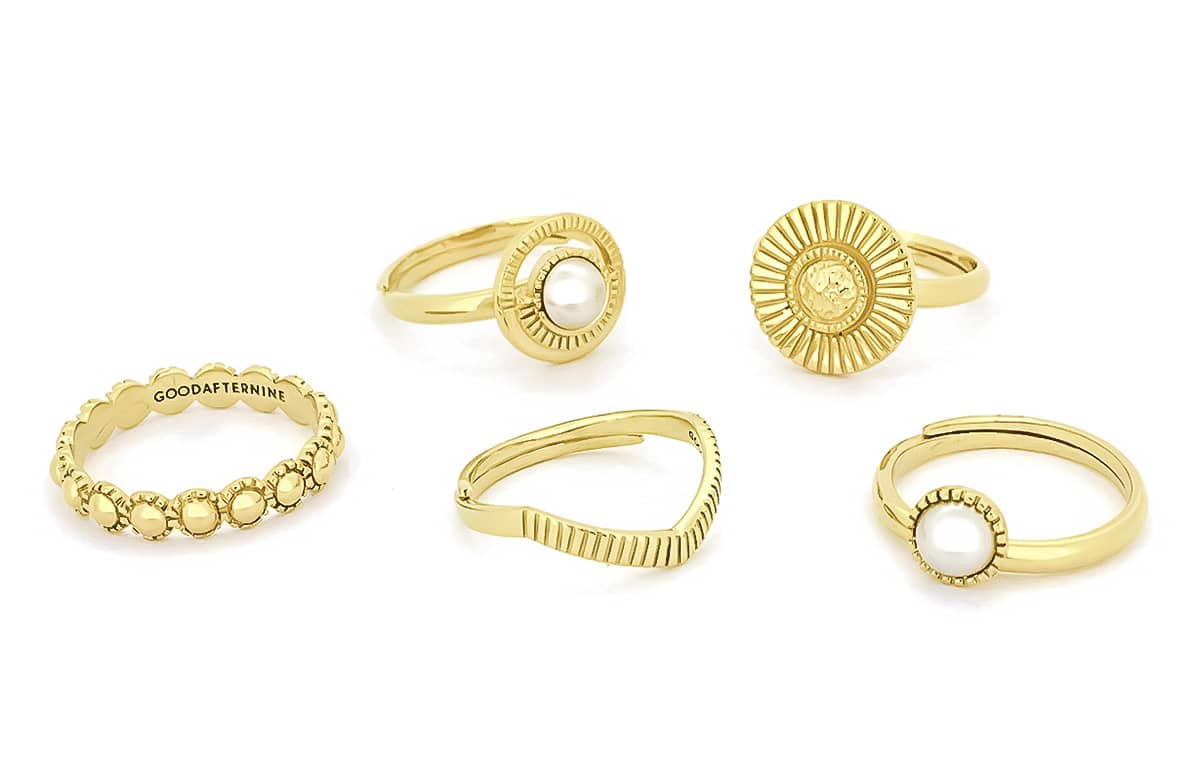 A collection of moon-inspired gold rings featuring various designs and textures.