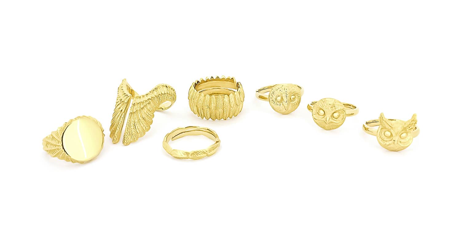 A collection of intricately designed gold animal rings featuring nature-inspired designs including feathers and owls.